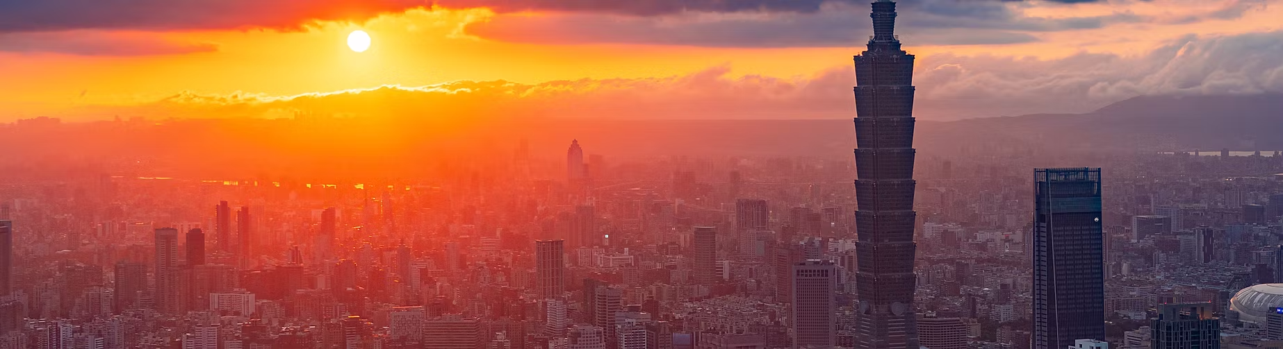 Paysage urbain avec des gratte-ciel dont la Tour de Taipei, au coucher du soleil avec des couleurs chaudes dans le ciel.