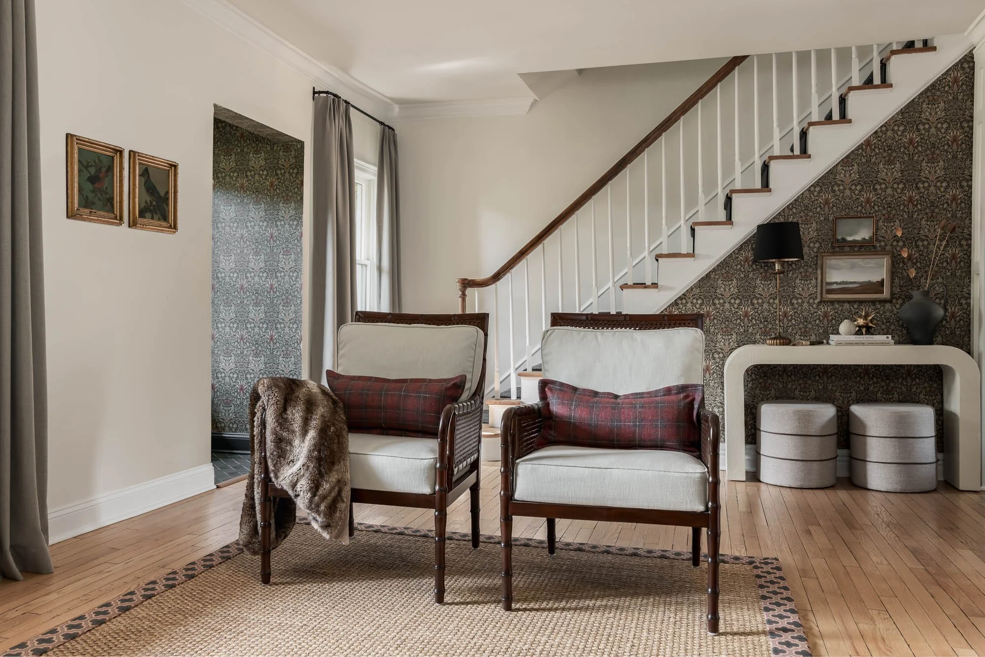 living room with two chairs and staircase 