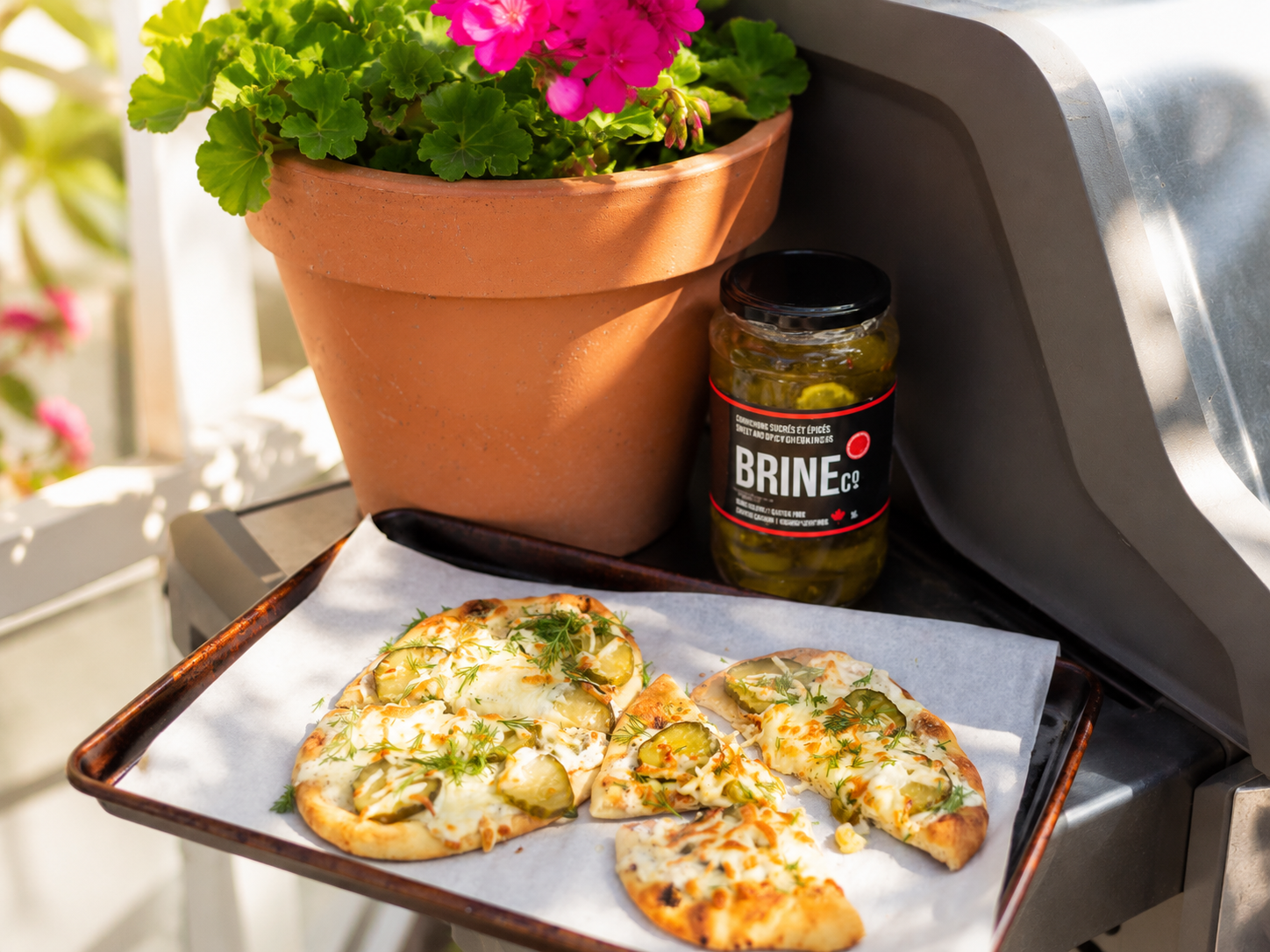 Pizza topped with Brine Co. pickles, cheese and fresh herbs.