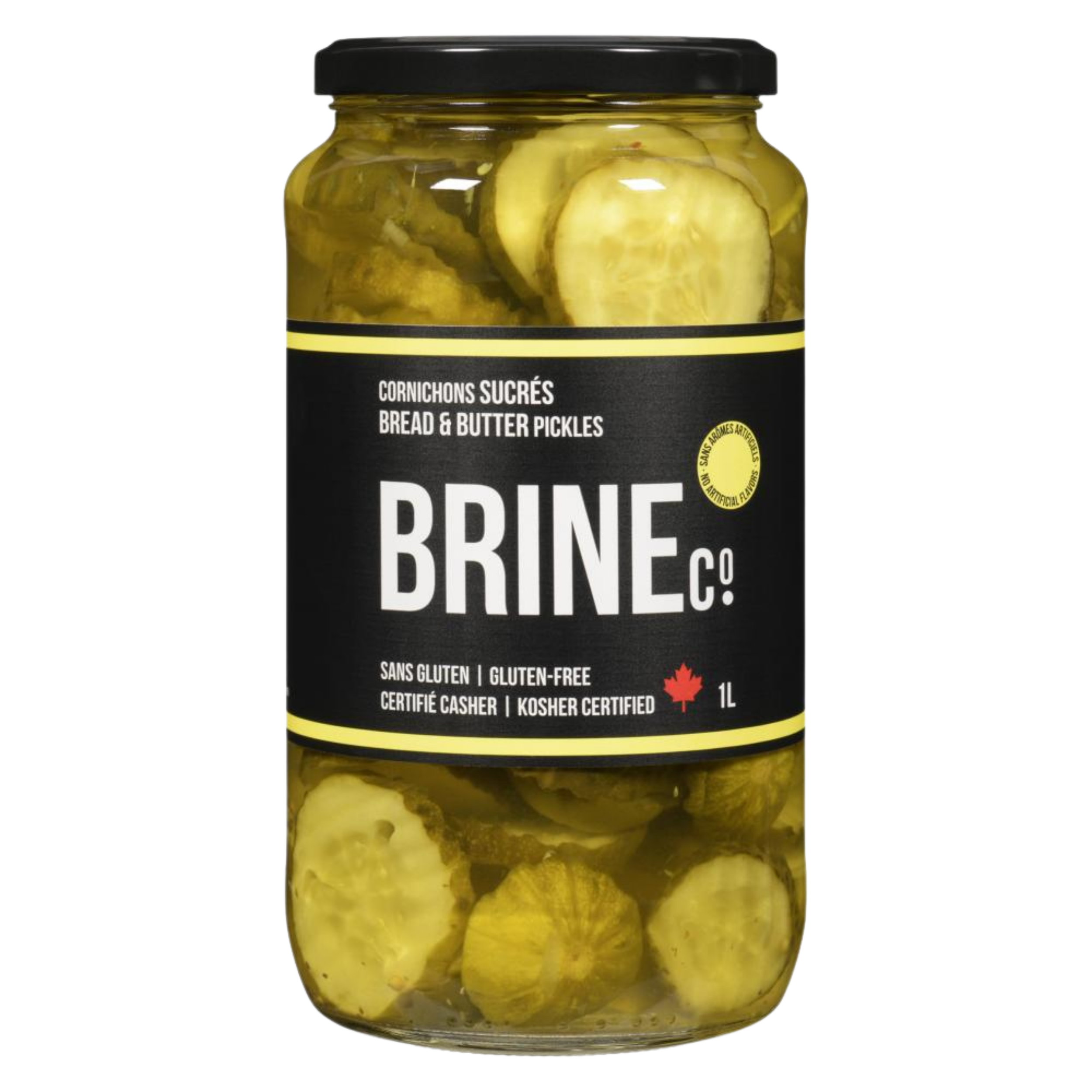 A glass jar of sweet bread and butter pickles labeled in French, English, and other languages, with a black lid and yellow and black labeling, showing sliced pickles inside.