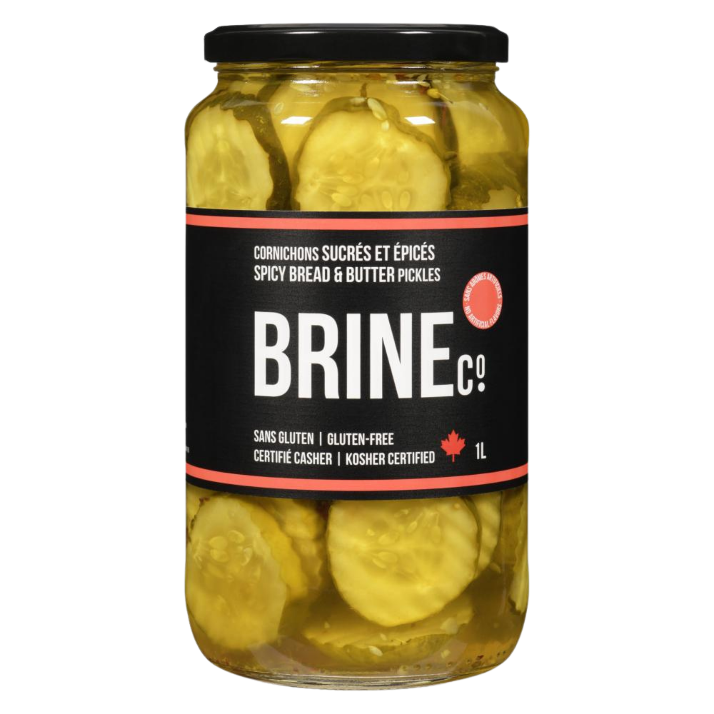 A glass jar filled with yellow pickles submerged in brine, with a black lid. The jar label indicates it contains spicy bread and butter pickles that are kosher and gluten-free, with a red maple leaf symbol.