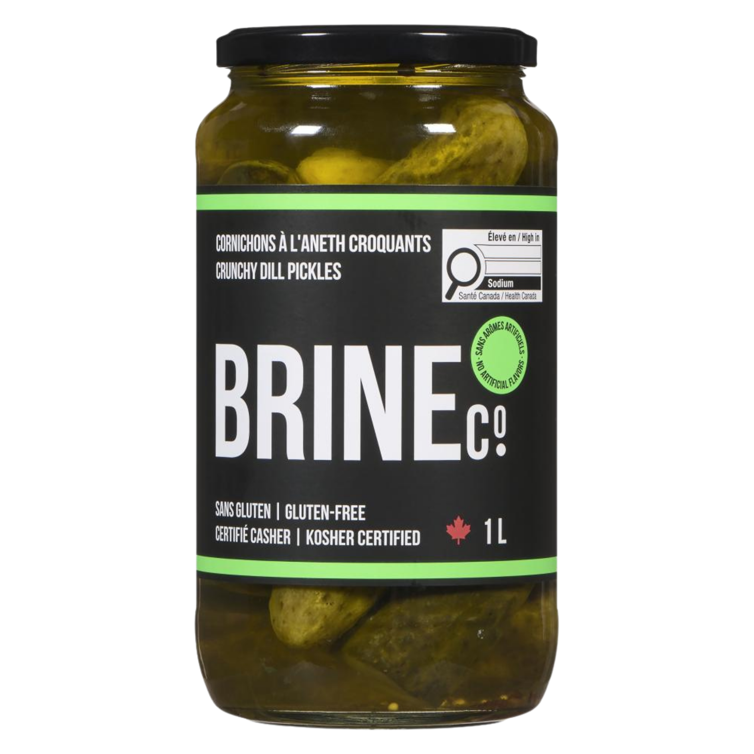 A jar of crunchy dill pickles labeled in French, English, and other languages, with a black lid and filled with pickles submerged in brine.