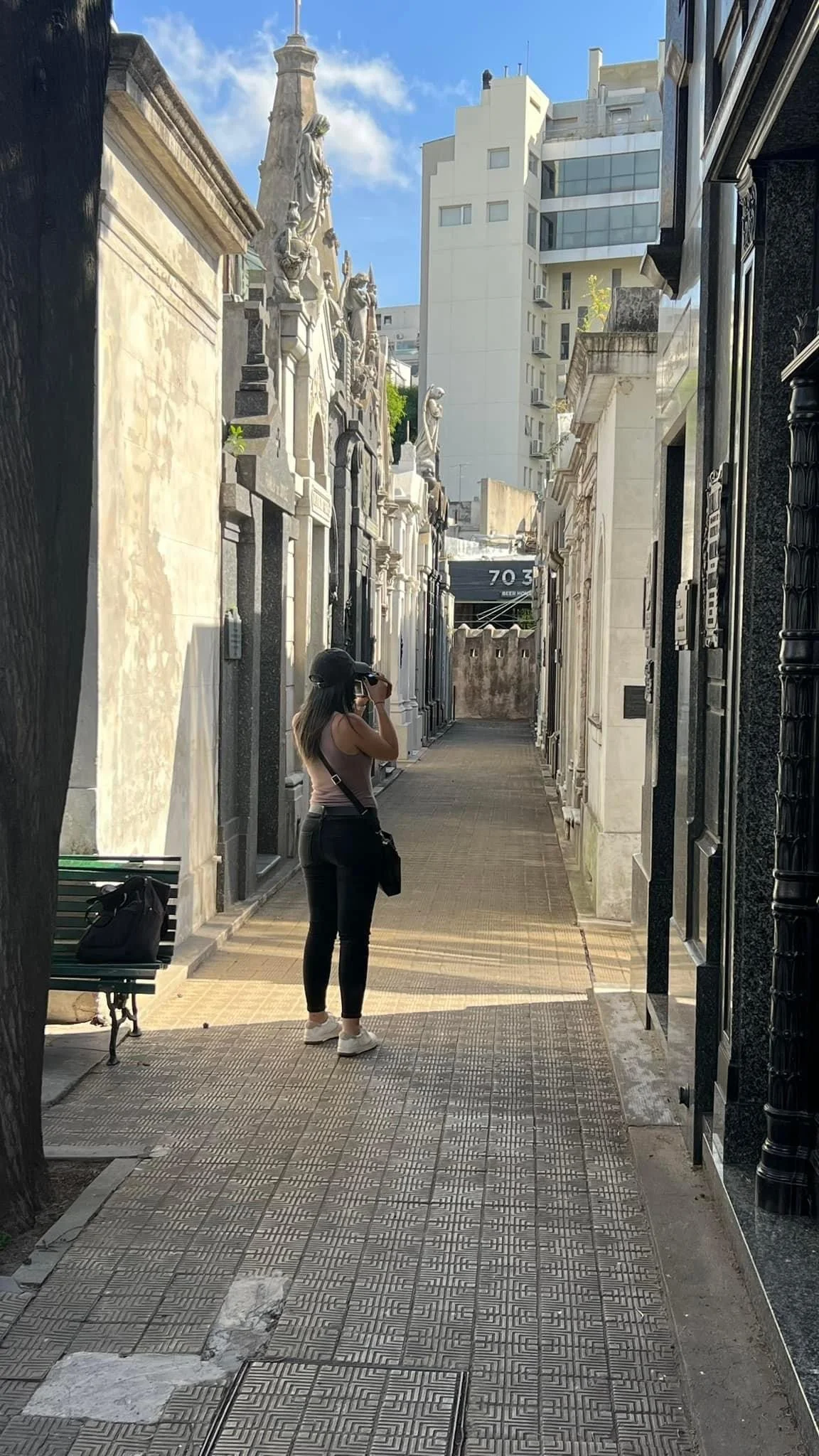 Megan Gonzalez taking a photo at the Recoleta Cemetery during an All About Ballroom dance retreat in Buenos Aires, Argentina.