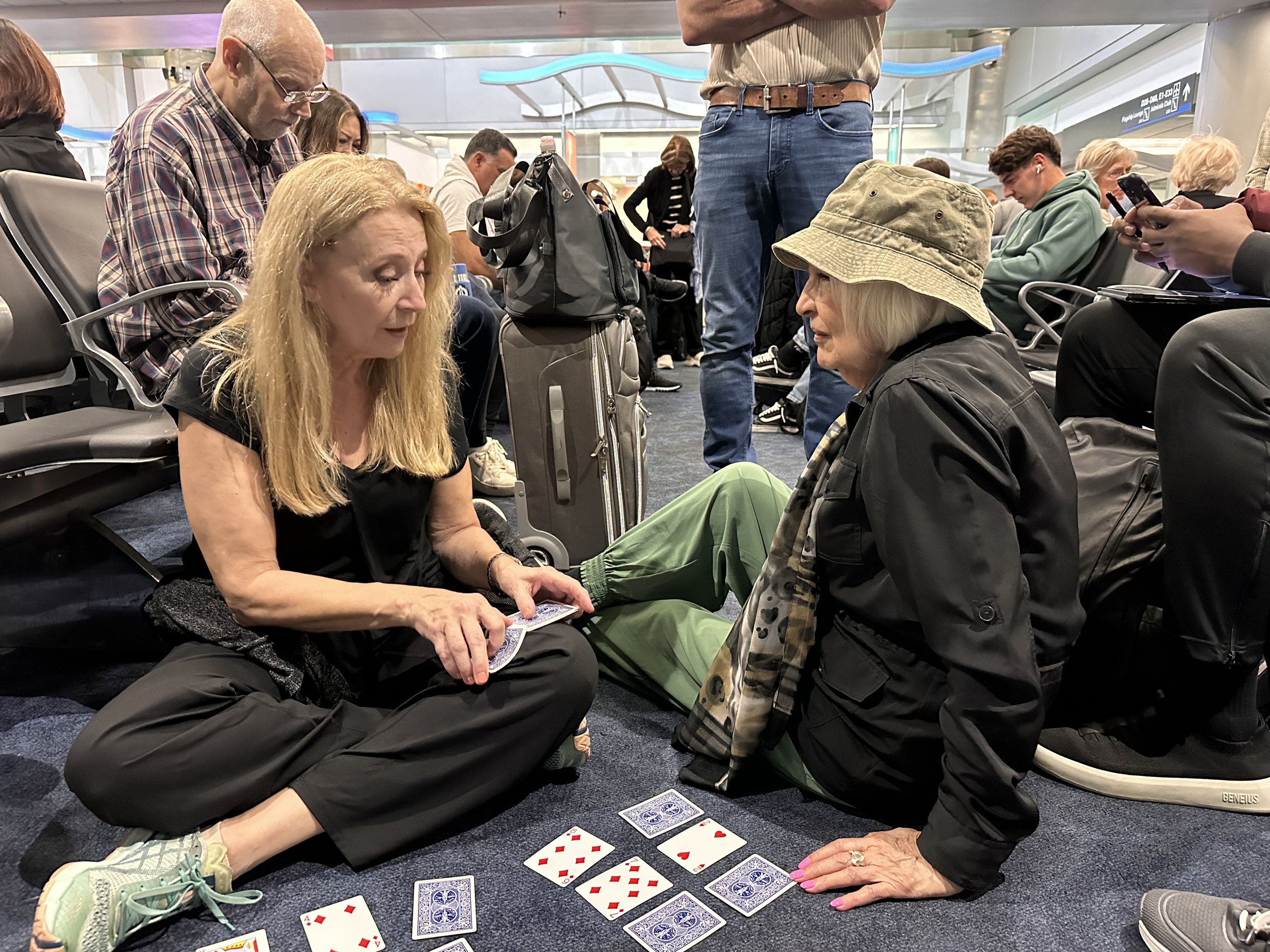 All About Ballroom travelers playing cards at the airport on the way to Argentina for a studio dance retreat.