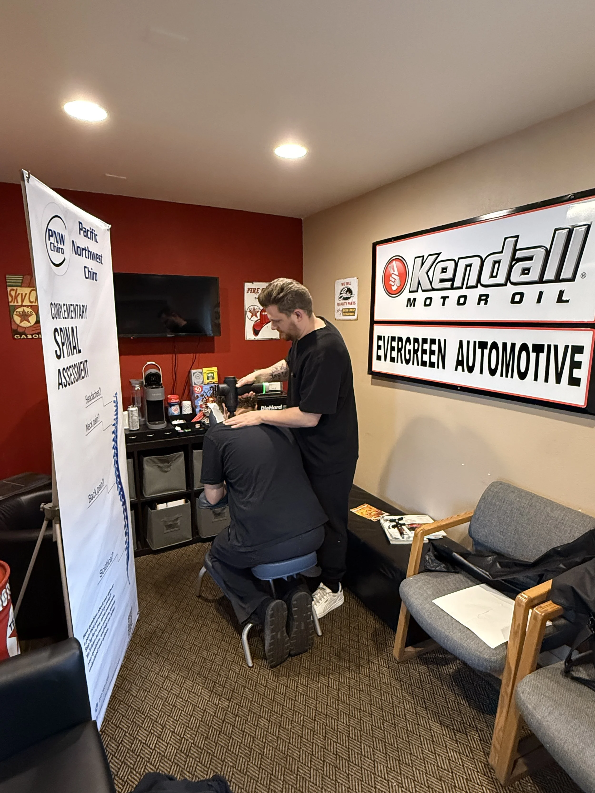 Dr. Huxley Cross providing a complimentary workplace spinal assessment at a local business event