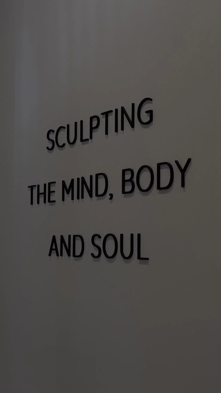 Sign on a wall that reads: 'Sculpting the mind, body, and soul'.