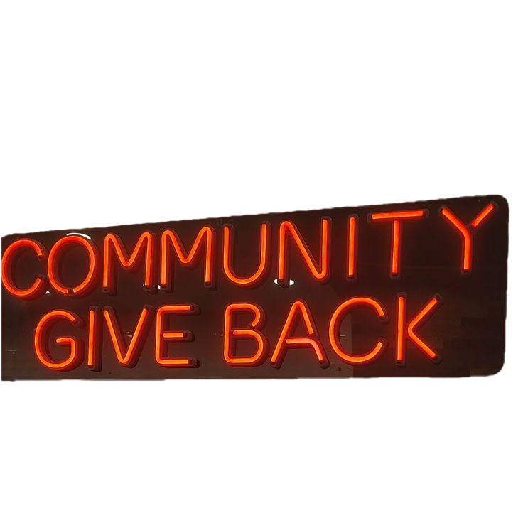 Neon sign reading 'Community Give Back' in red.