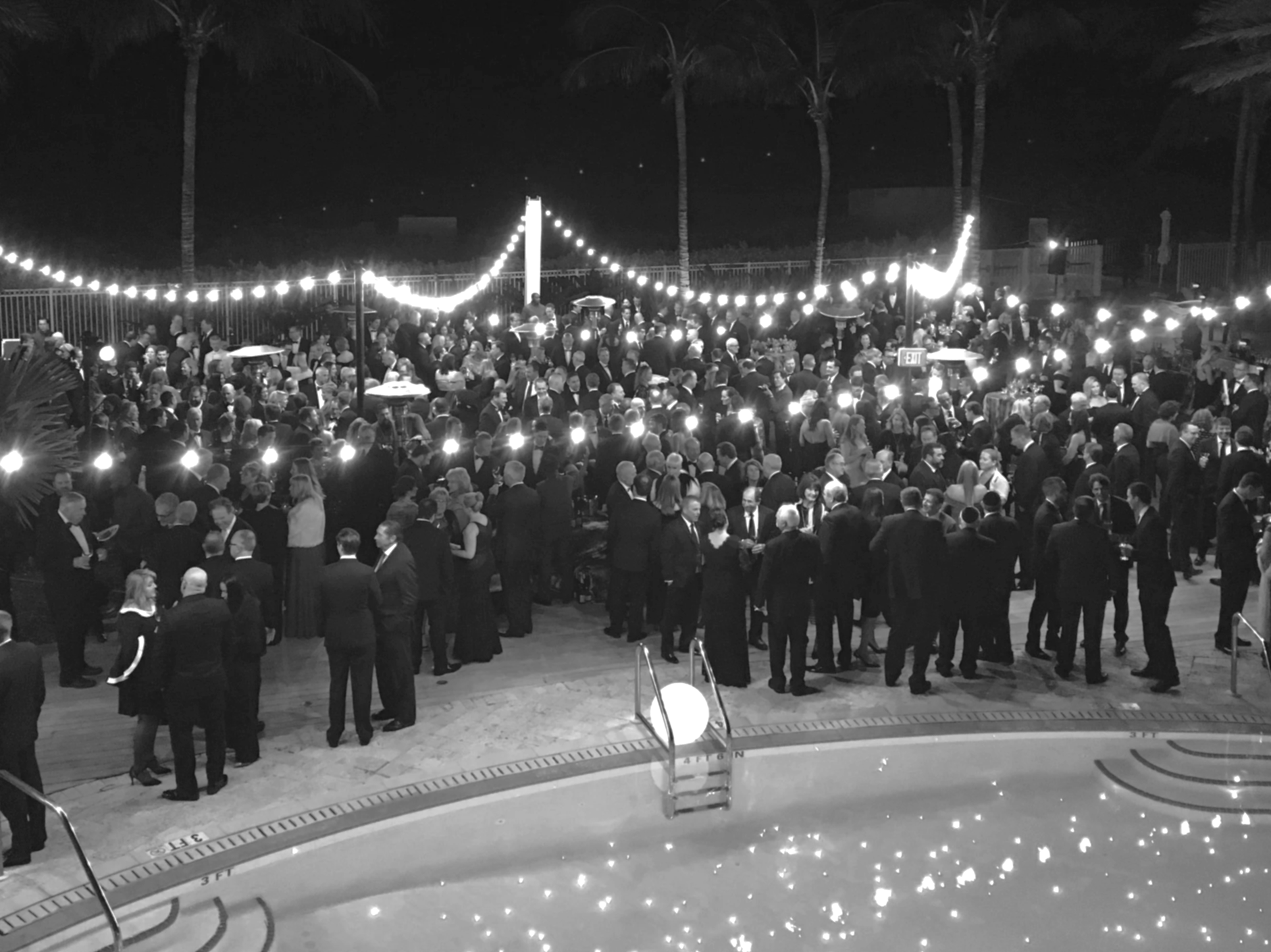Guests gathered at an elegant outdoor evening event.