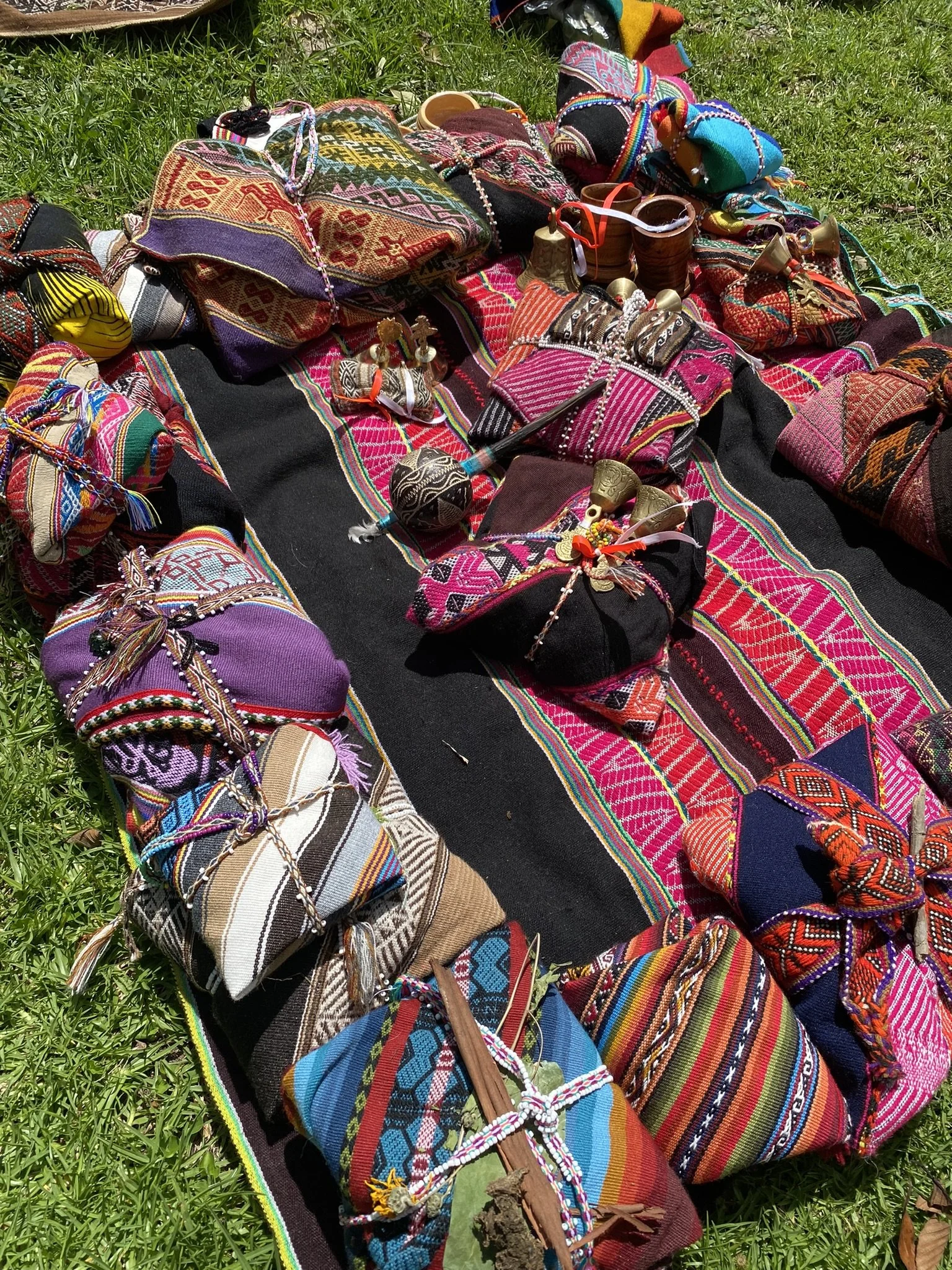 Several Mesas Laying on Peruvian hand woven garments for ceremony