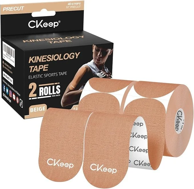 Box of CK Keep Kinesiologi Tape with two beige rolls of adhesive sports tape partially unrolled in front of the box.