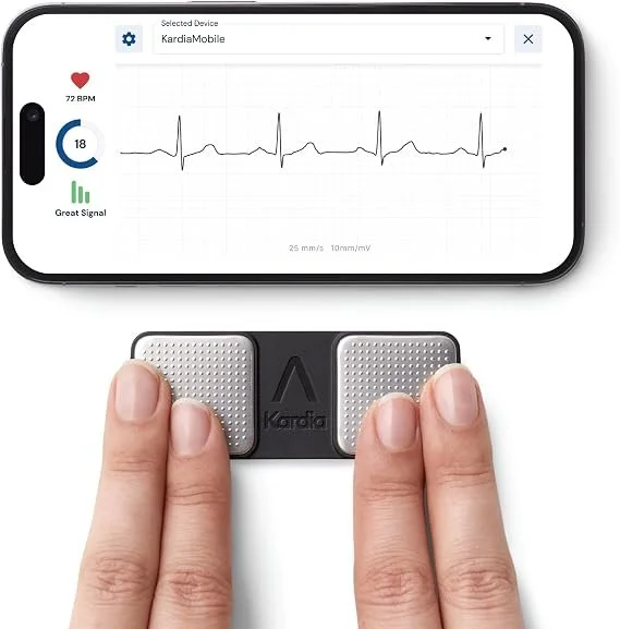 A person using a KardiaMobile device to take an ECG reading, with a smartphone displaying the heart rate of 72 BPM, 18 on the count, and a 'Great Signal' indicator.