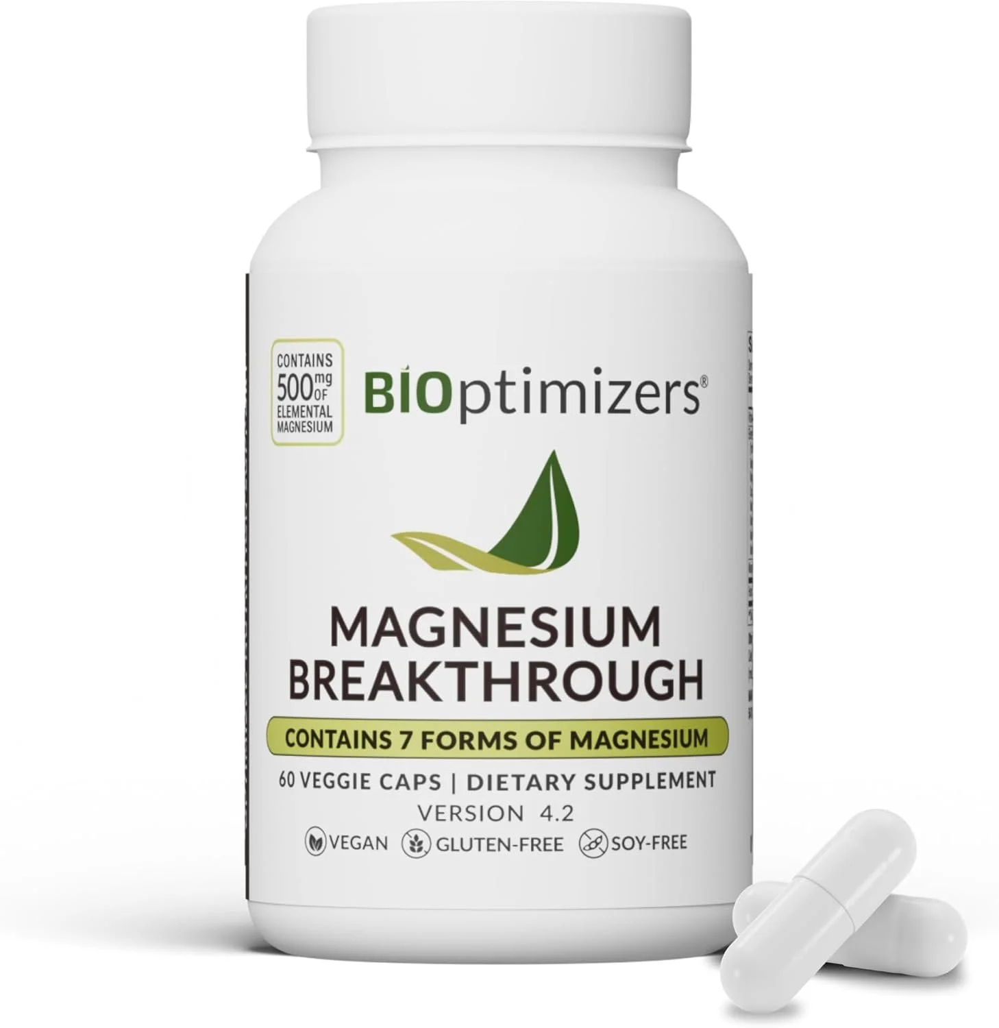 Bottle of BIOpTIMIZERS Magnesium Breakthrough dietary supplement with 60 veggie capsules, containing 7 forms of magnesium, vegan, gluten-free, soy-free, version 4.2, with some capsules in front of the bottle.