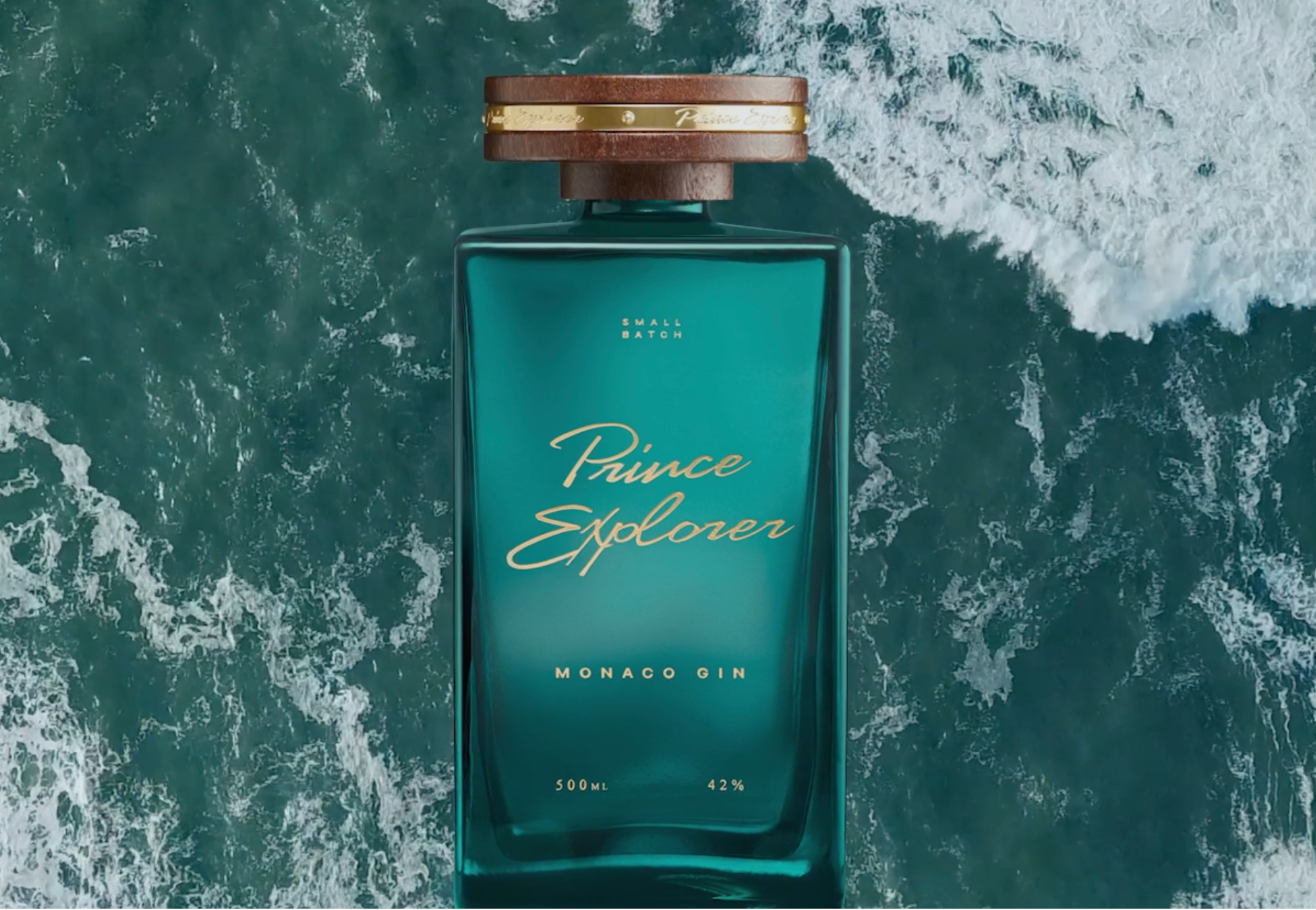A bottle of Prince Salonen Monaco Gin floating on water with waves crashing around it.