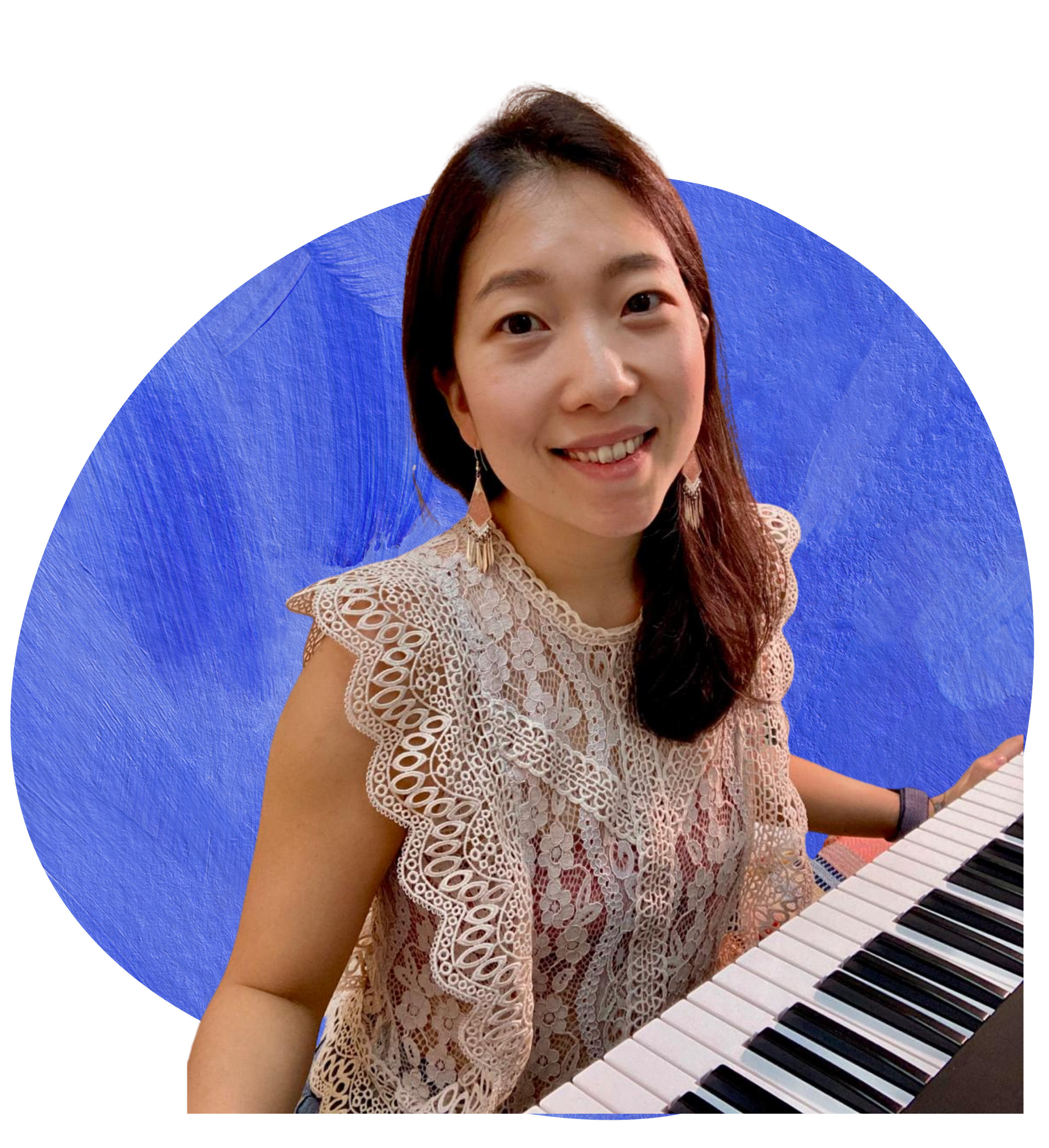 A woman with long dark hair, wearing a beige crochet lace top, playing a keyboard piano. She has earrings and a watch, and is smiling as she looks at the camera. The background is black with a blue circular shape behind her.