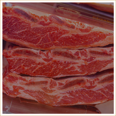 Close-up of three raw beef steaks with marbling.
