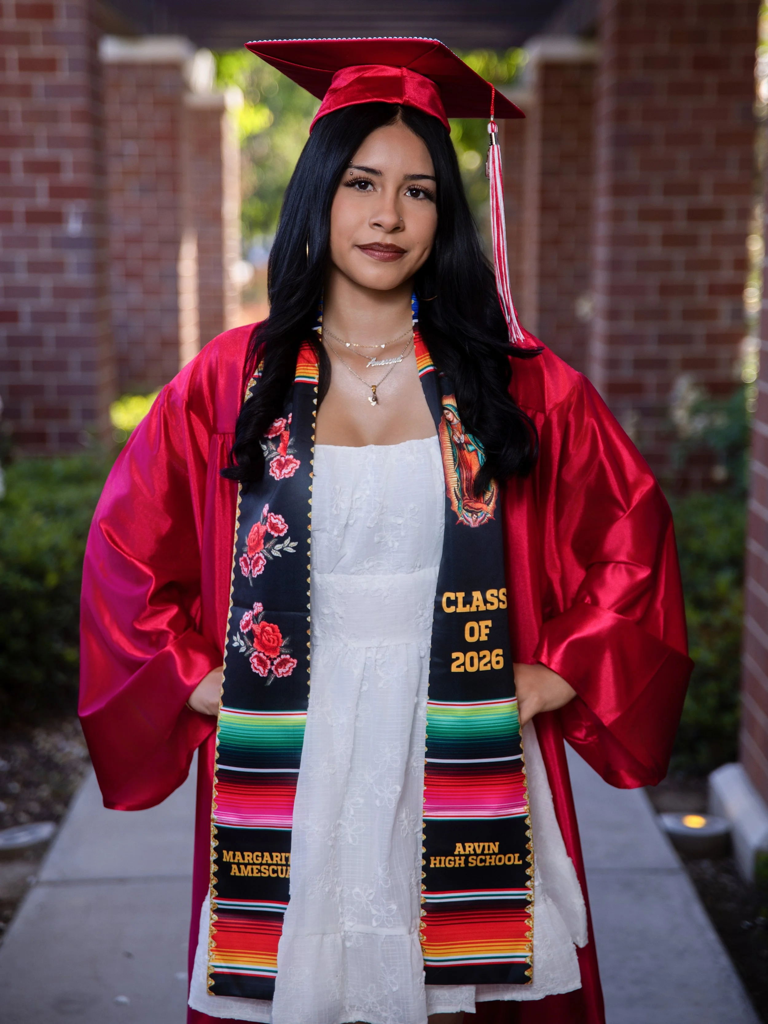 Arvin High School Class of 2026 senior graduation portrait featuring a graduate in a red cap and gown with a colorful graduation stole, professionally photographed in Bakersfield, California.