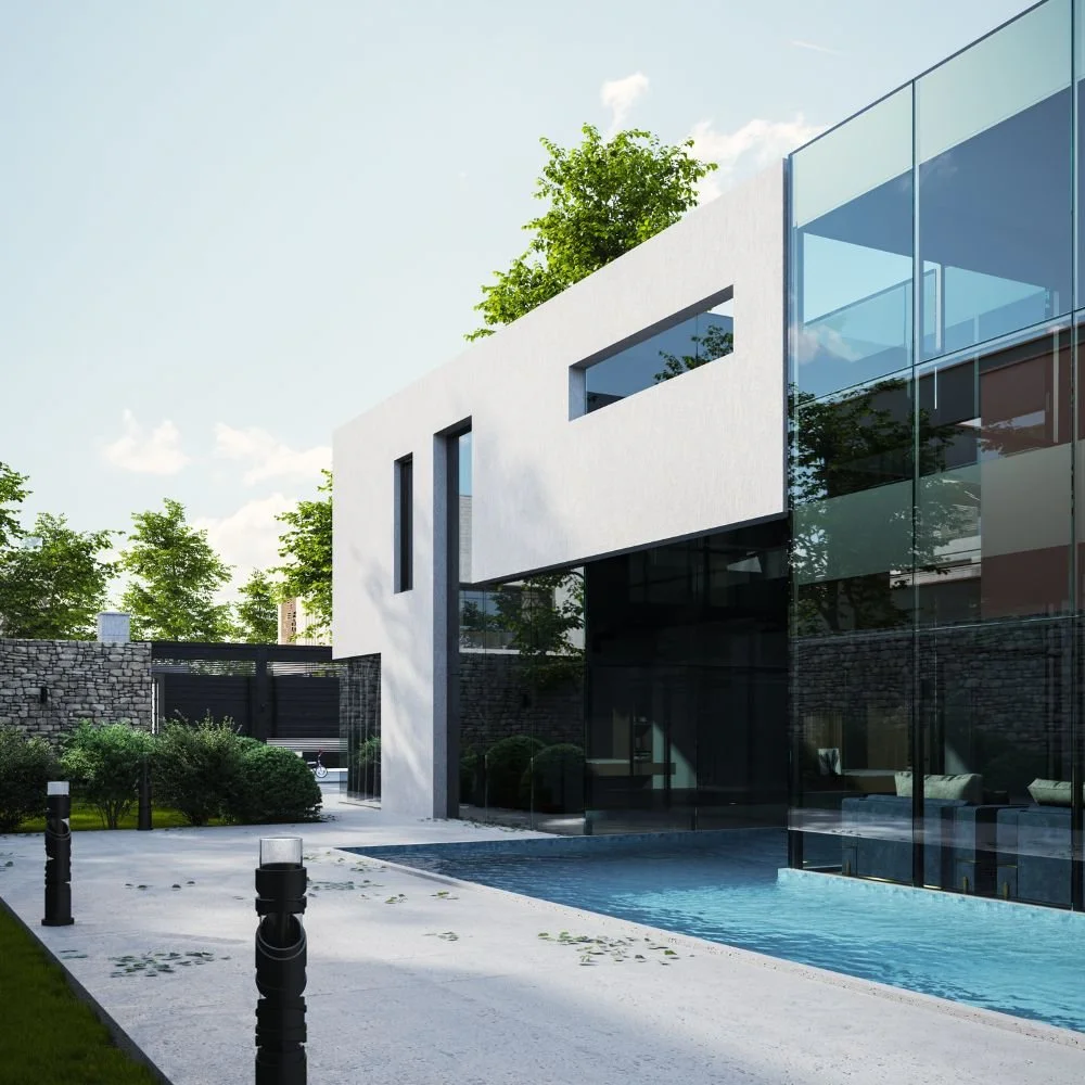 Modern white house with large glass windows and a pool in the backyard, surrounded by trees and stone wall.