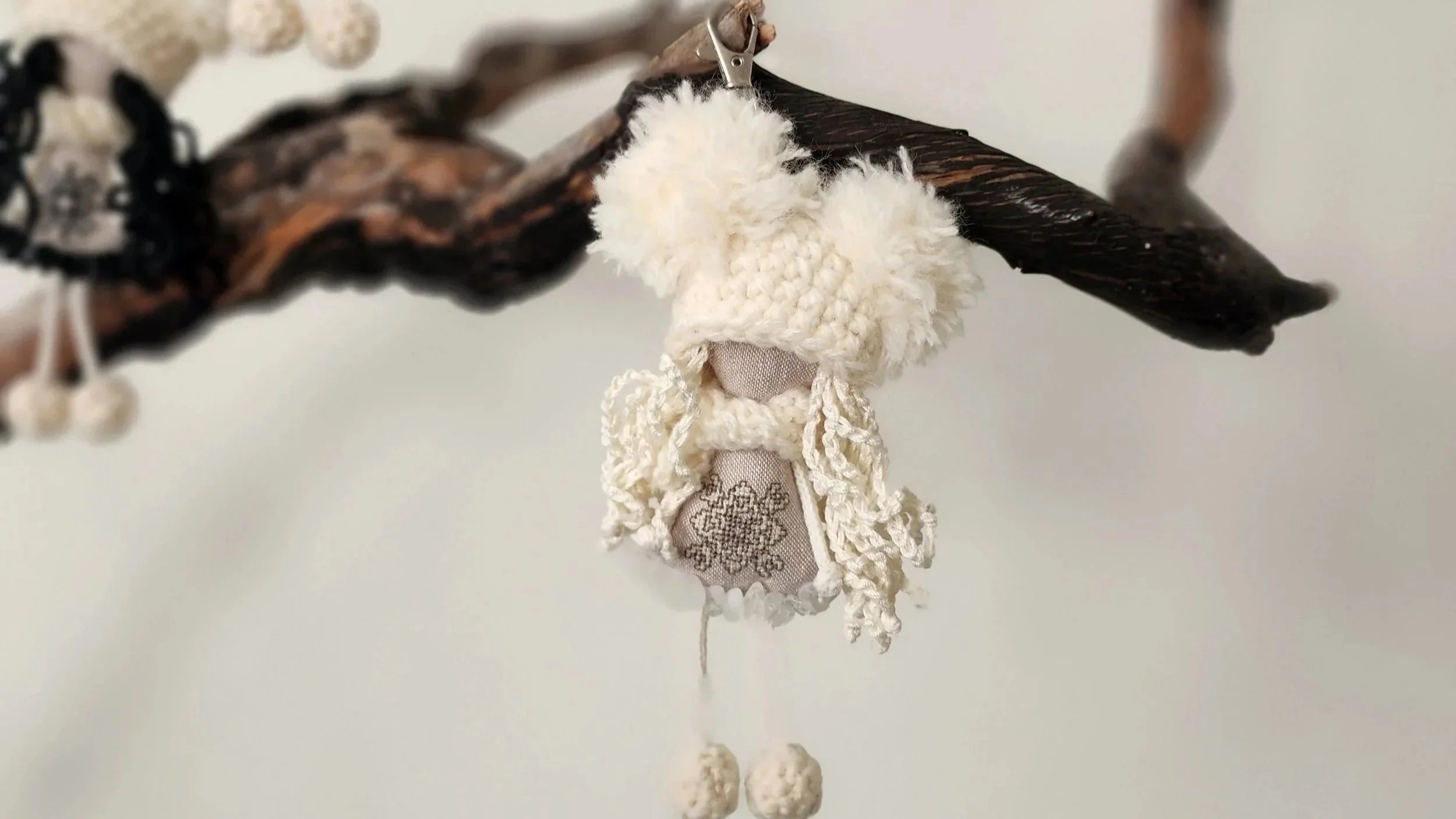 Handmade OMMi companion with an embroidered encoded intention ornament