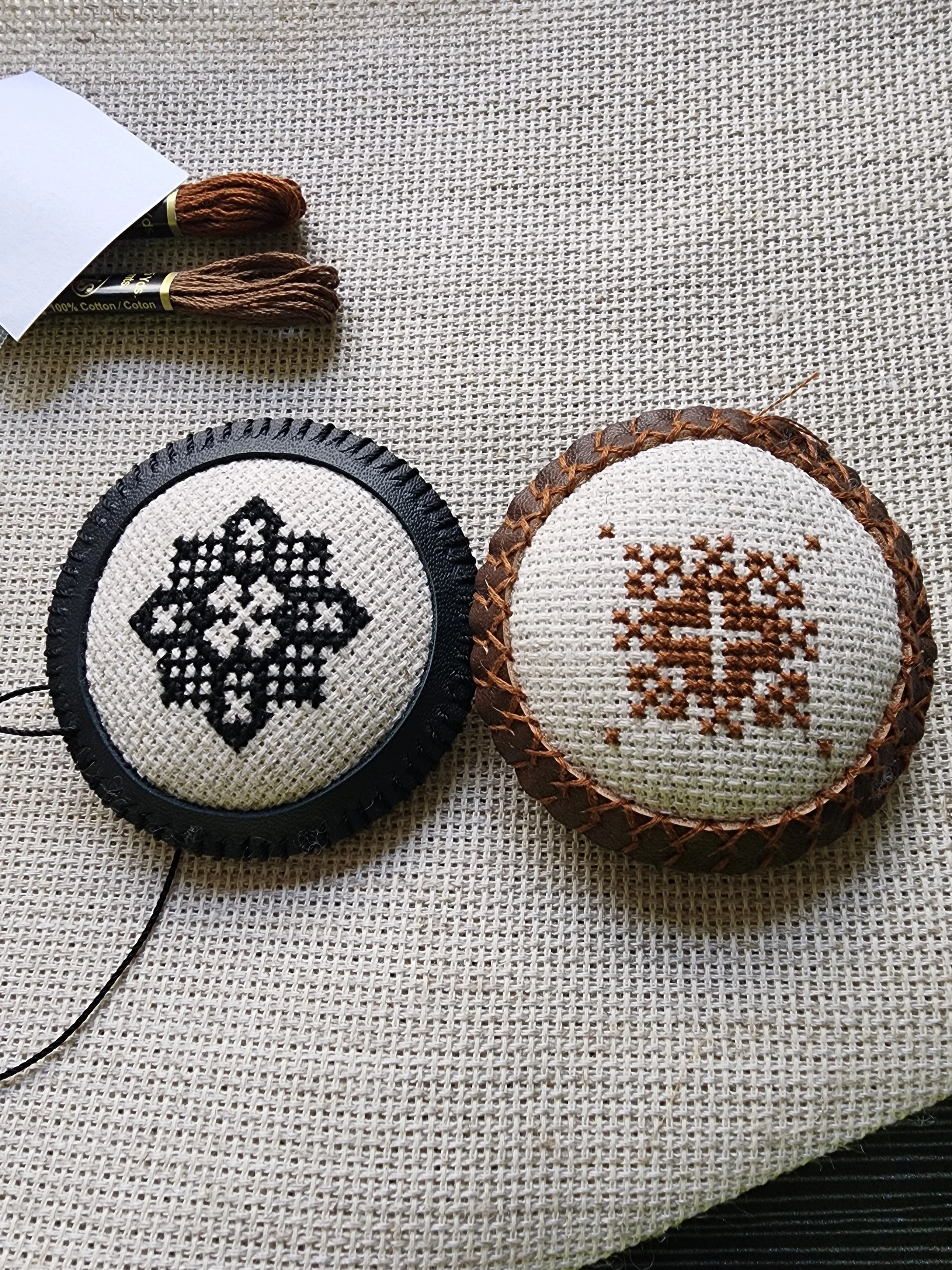 Encoded Intention geometric word ornaments embroidered in cross stitch on linen