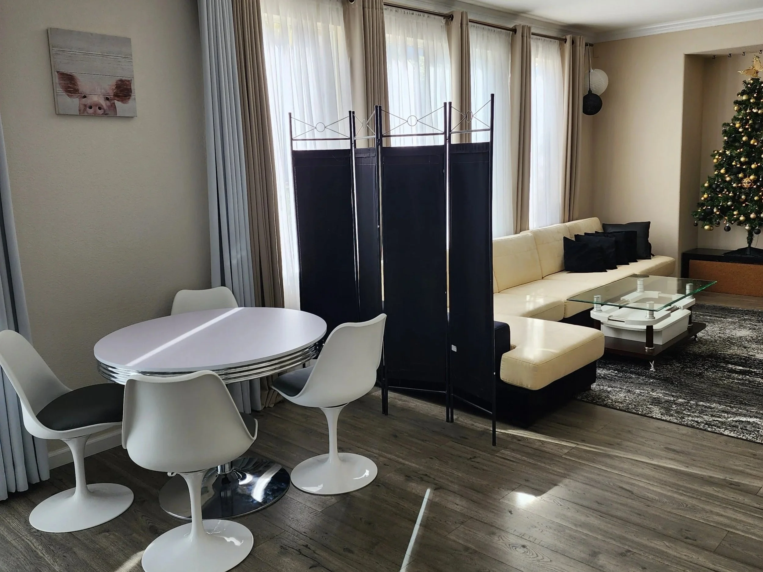 Black folding room divider used to separate the open living and dining space