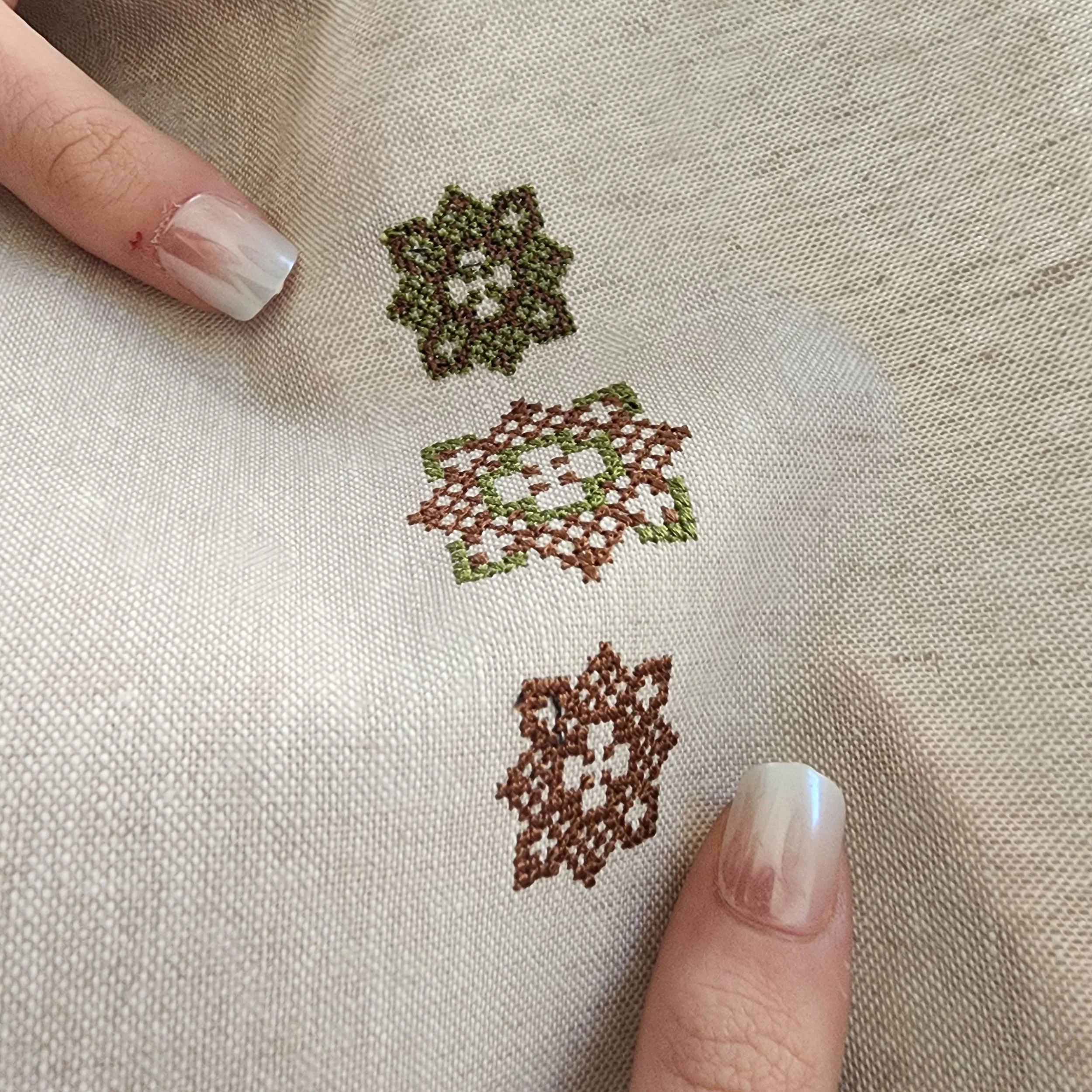 Encoded Intention geometric word ornaments embroidered on linen