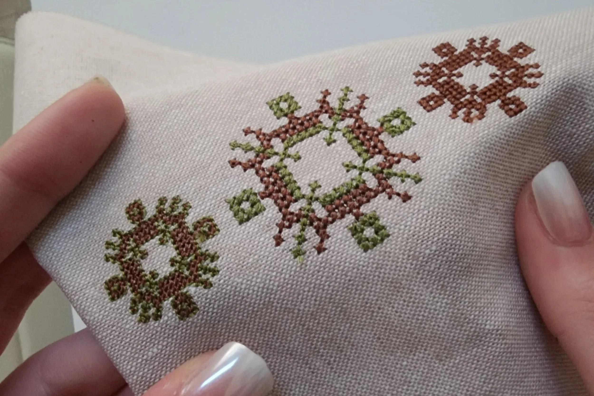 Machine embroidered Encoded Intention geometric word ornaments on fabric