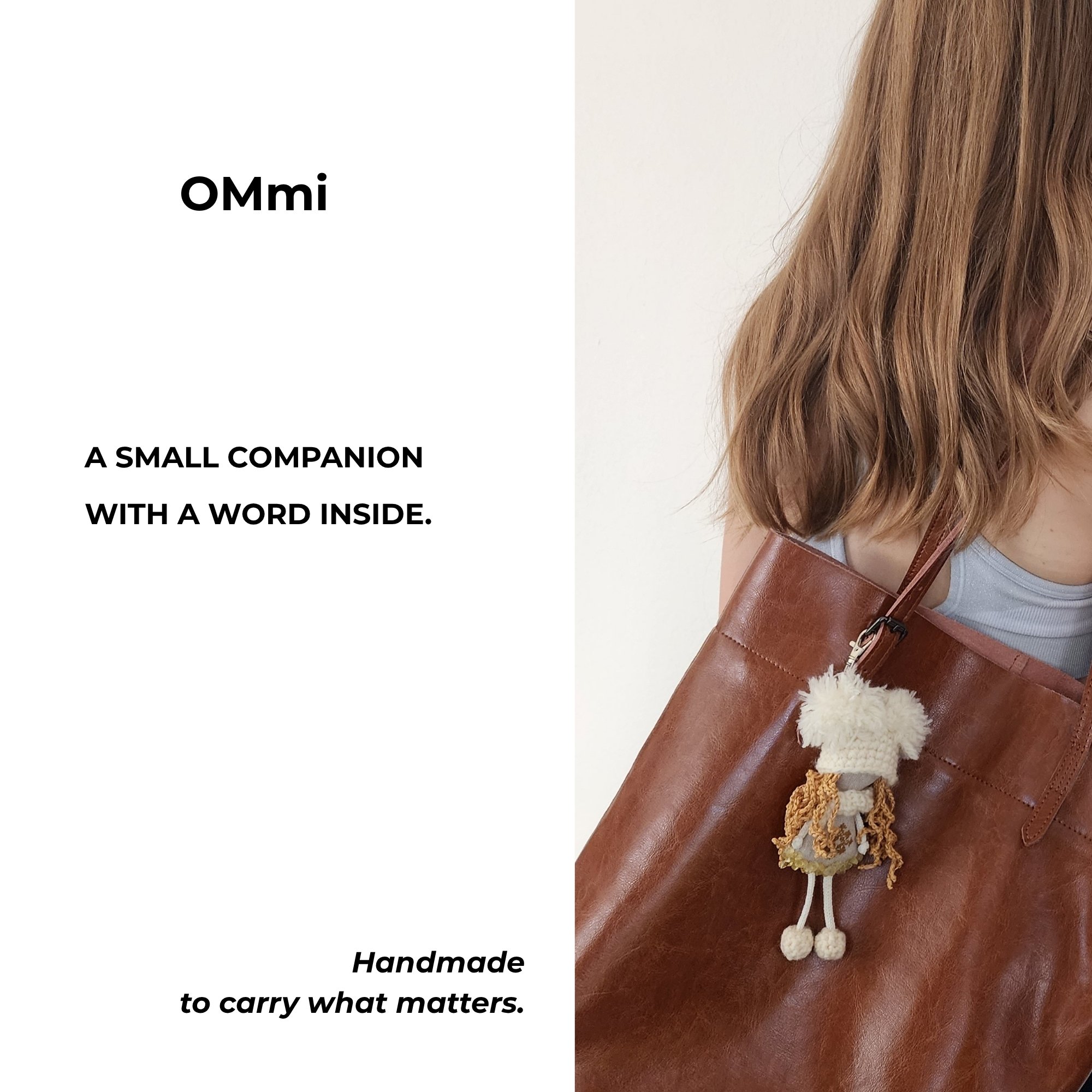 OMmi hanging from a brown leather tote bag with text describing it as a small handmade companion with a word inside.