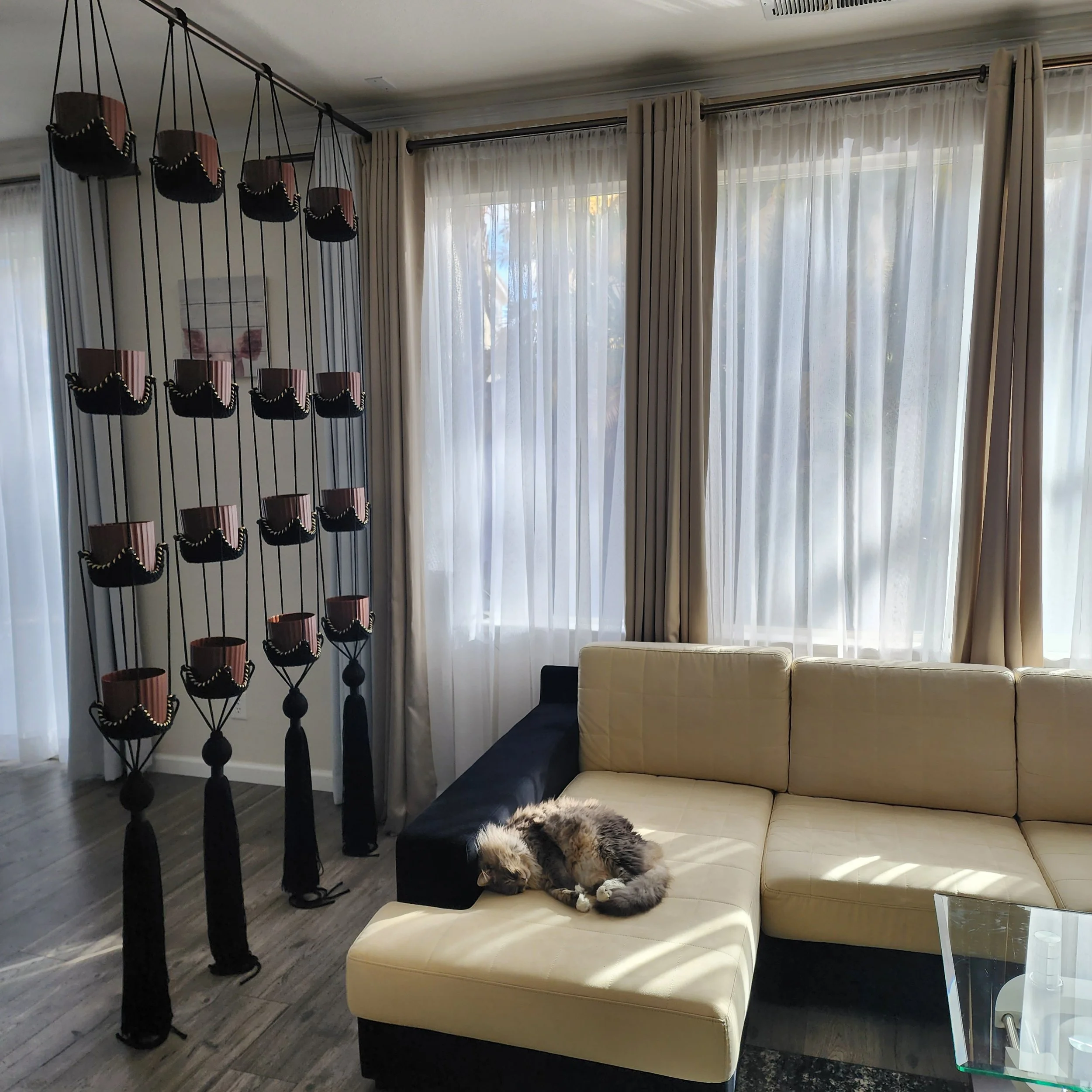 OMM Depot custom knitted vertical plant hangers with multiple pot shelves in a living room