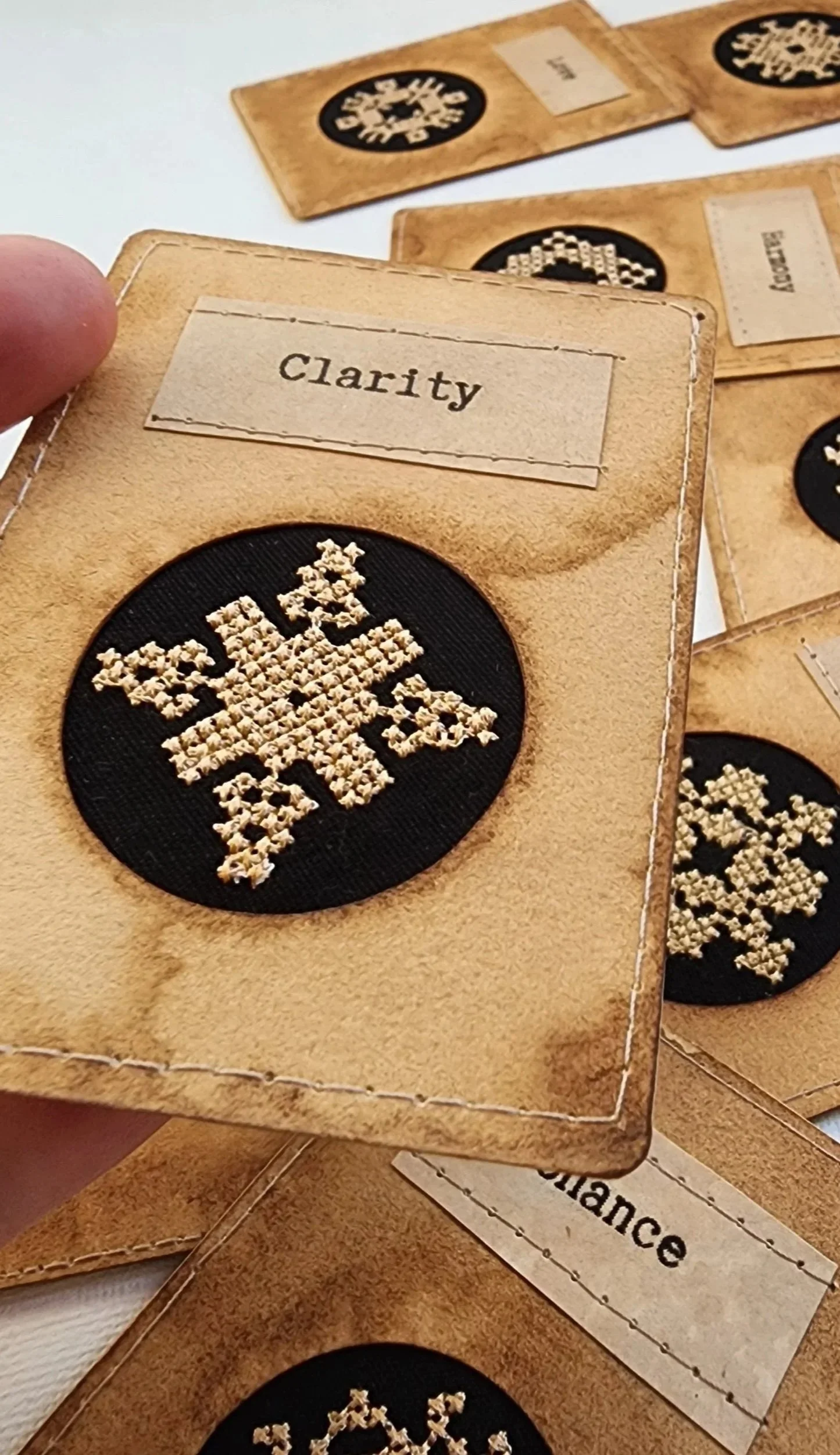 Encoded Intention word cards showing geometric embroidery ornaments for Clarity and other words