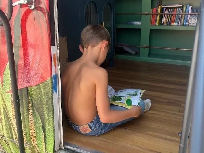 kid reading a children's book on bfb book nerd mobile