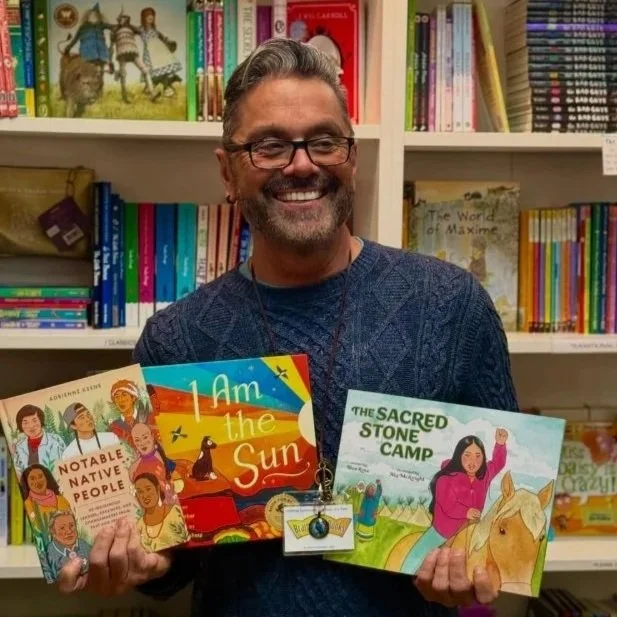 cal crosby holding books and smiling