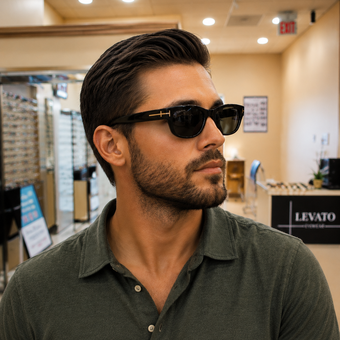 Man wearing black sunglasses in eyewear store.
