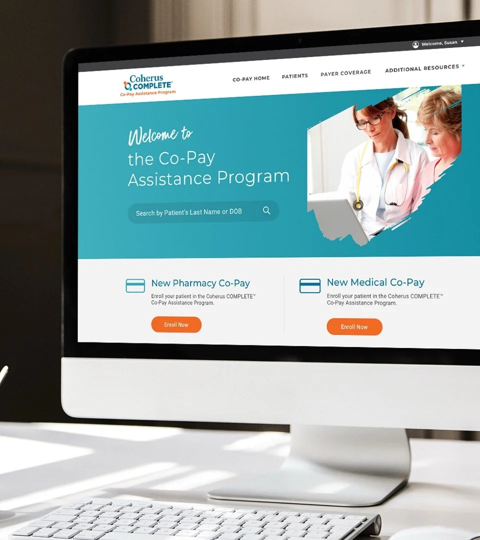 Computer screen displaying the Co-Pay Assistance Program website with options for pharmacy and medical co-pay enrollment, and a photo of two healthcare professionals.