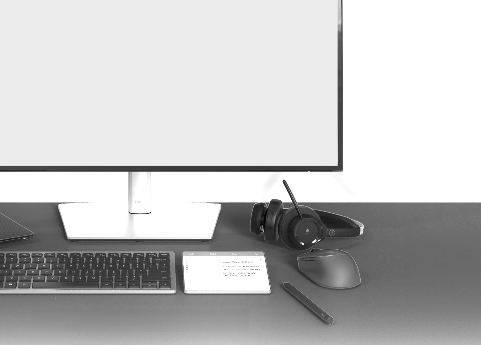 A workspace featuring a desktop computer monitor, a wireless keyboard, a wireless mouse, a notebook with handwritten notes, a pen, headphones, and a closed laptop on a dark desk.