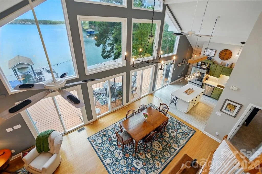 Open-concept waterfront living room overlooking Lake Wylie SC in a custom Tega Cay home represented by Realtor Penny Sheppard