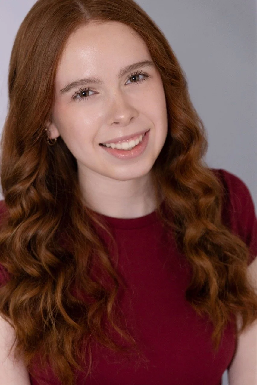 Kassia smiling in a red shirt
