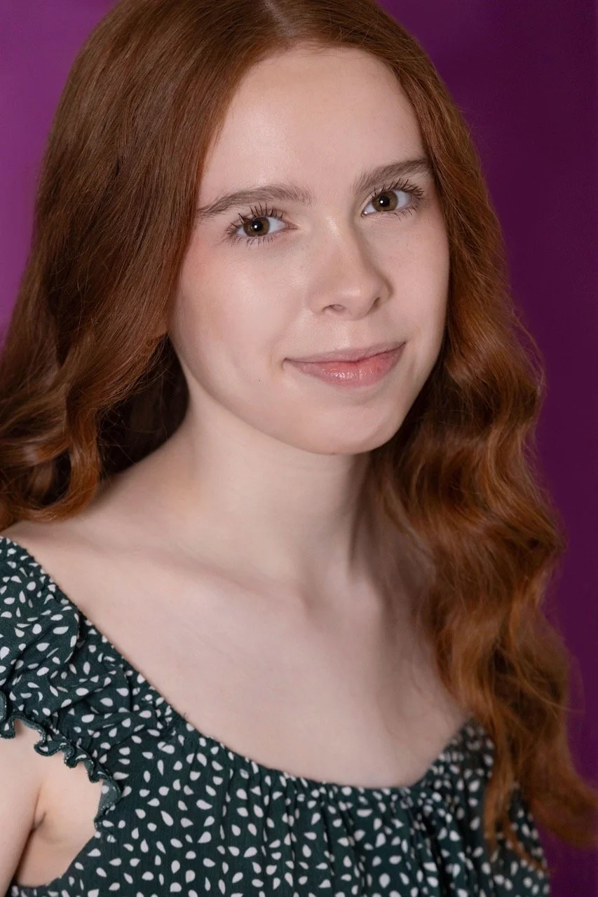 Kassia in a green top smiling lightly