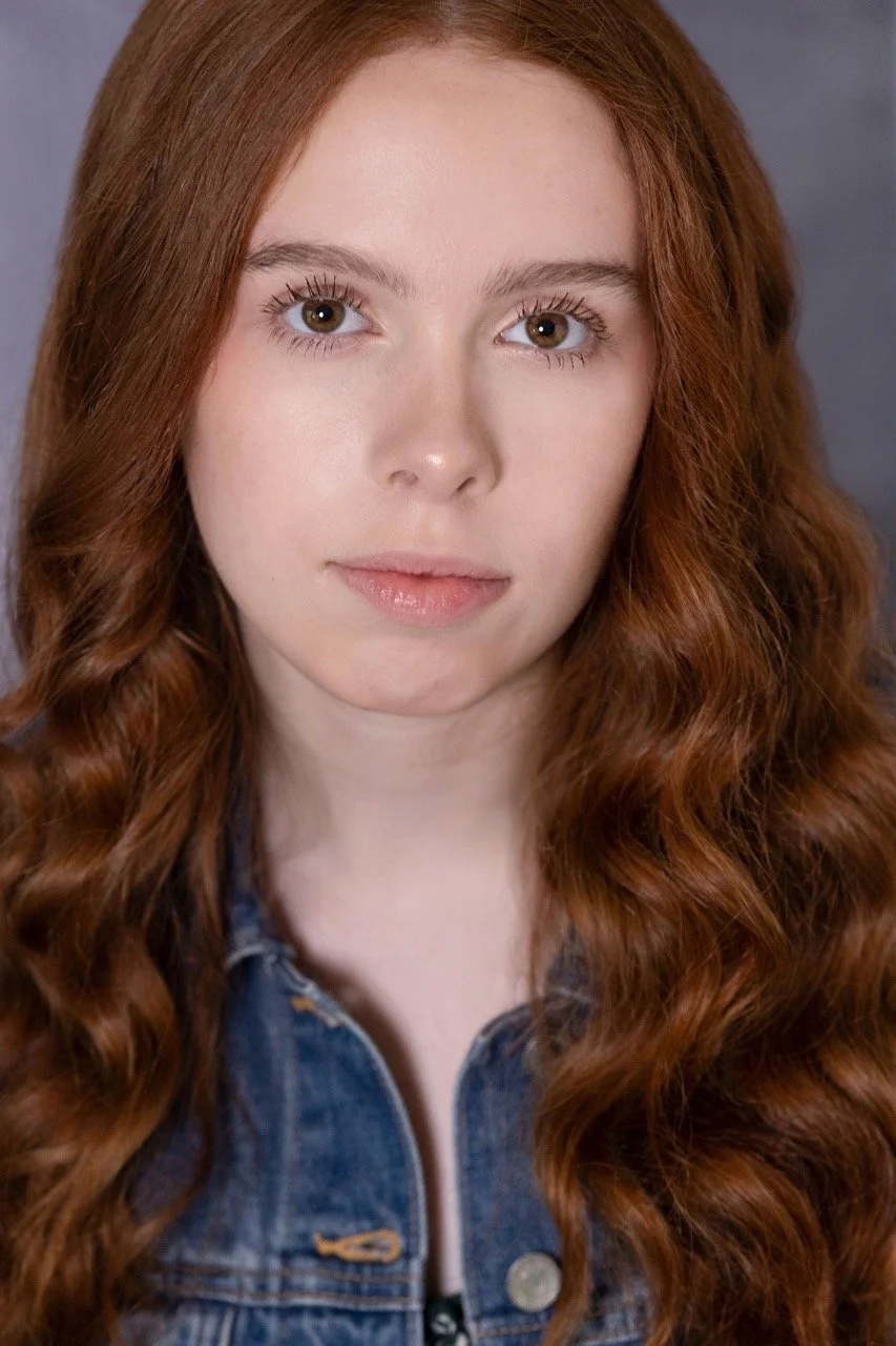 Kassia in a denim jacket, looking serious