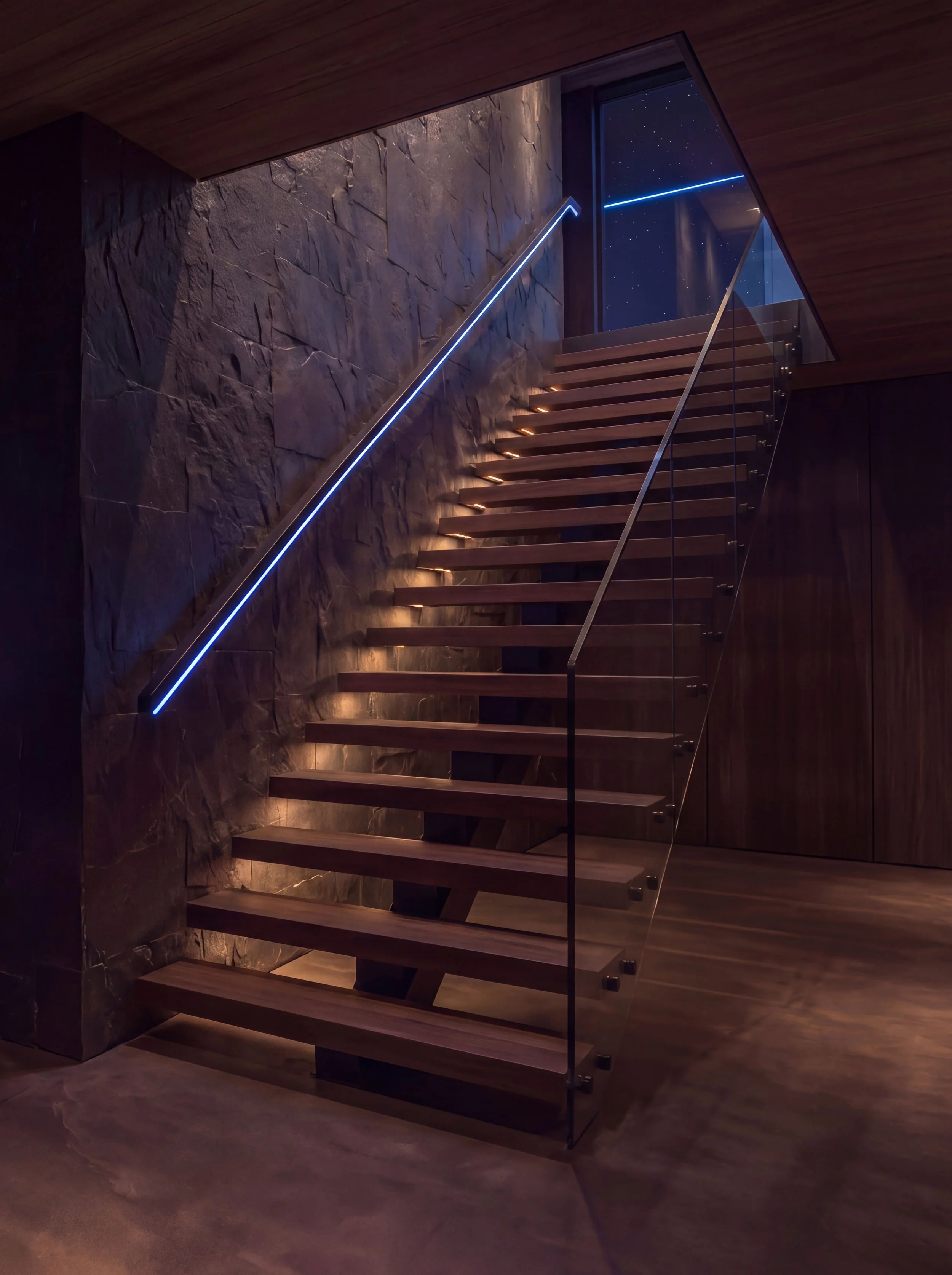An empty wooden staircase lit by a blue light line running along the handrail, a window at the top showing a starry night sky.