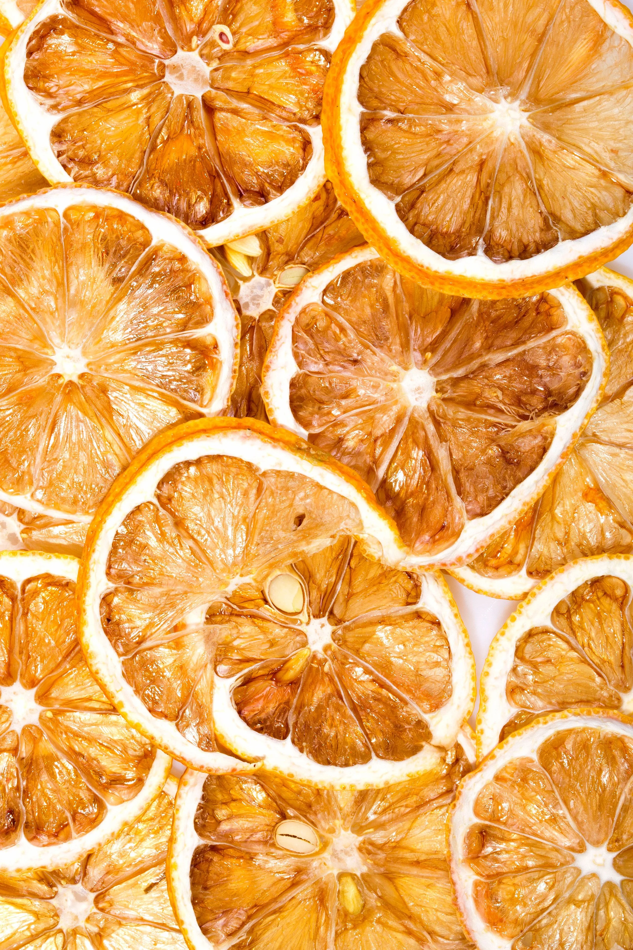 Close-up of dried orange slices layered together, showing the textured interior and rind.