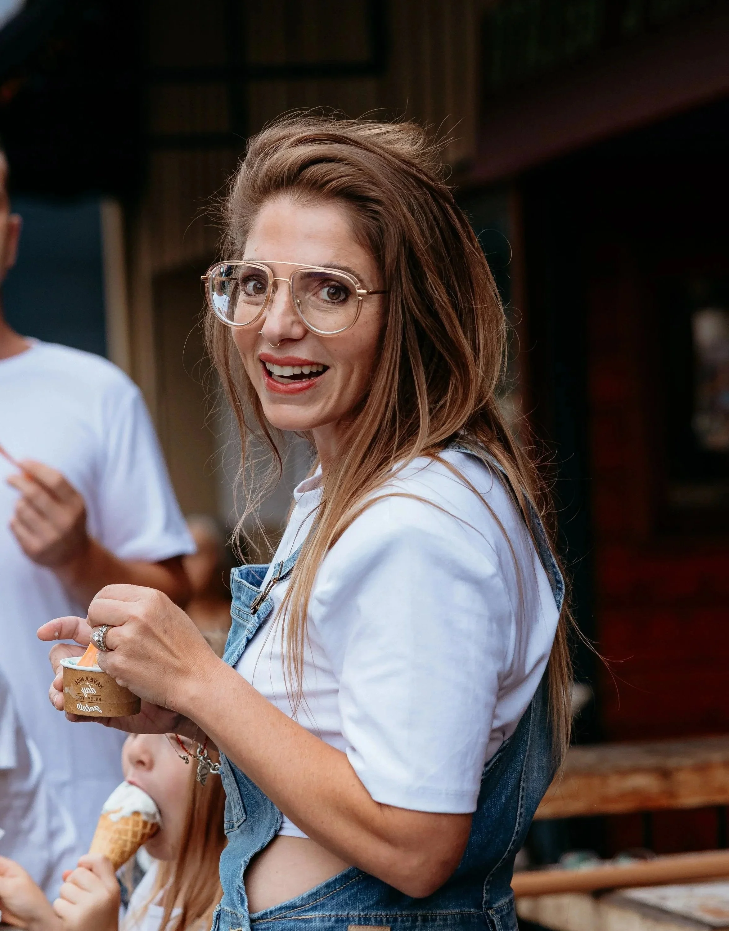 Sara smiles while holding an ice cream from Mike's Place.