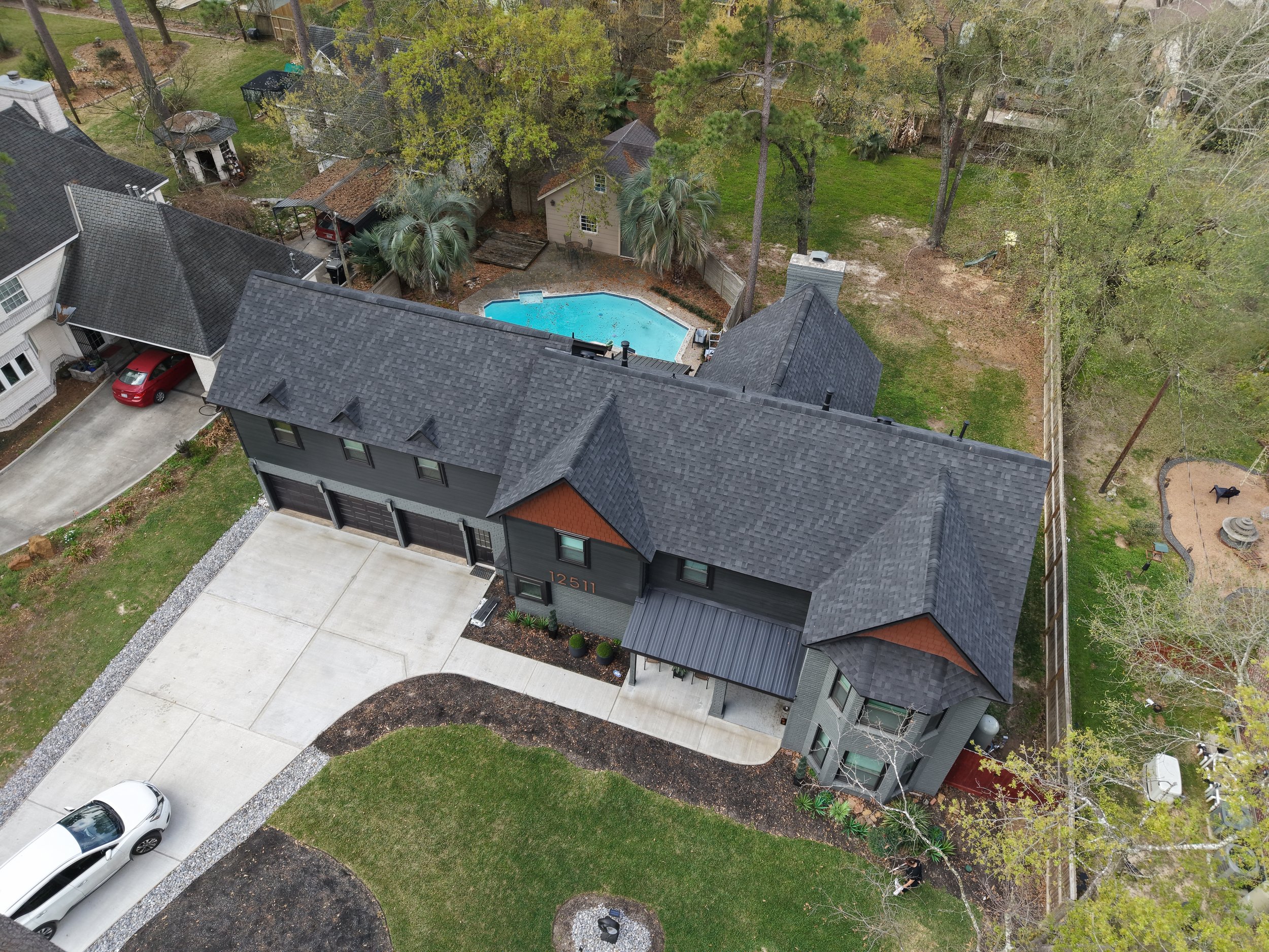 TurnKey Roofing & Restoration — An aerial view of a newly shingled large dark roof in Cypress (Houston), Texas, using Owens Corning Shingles.