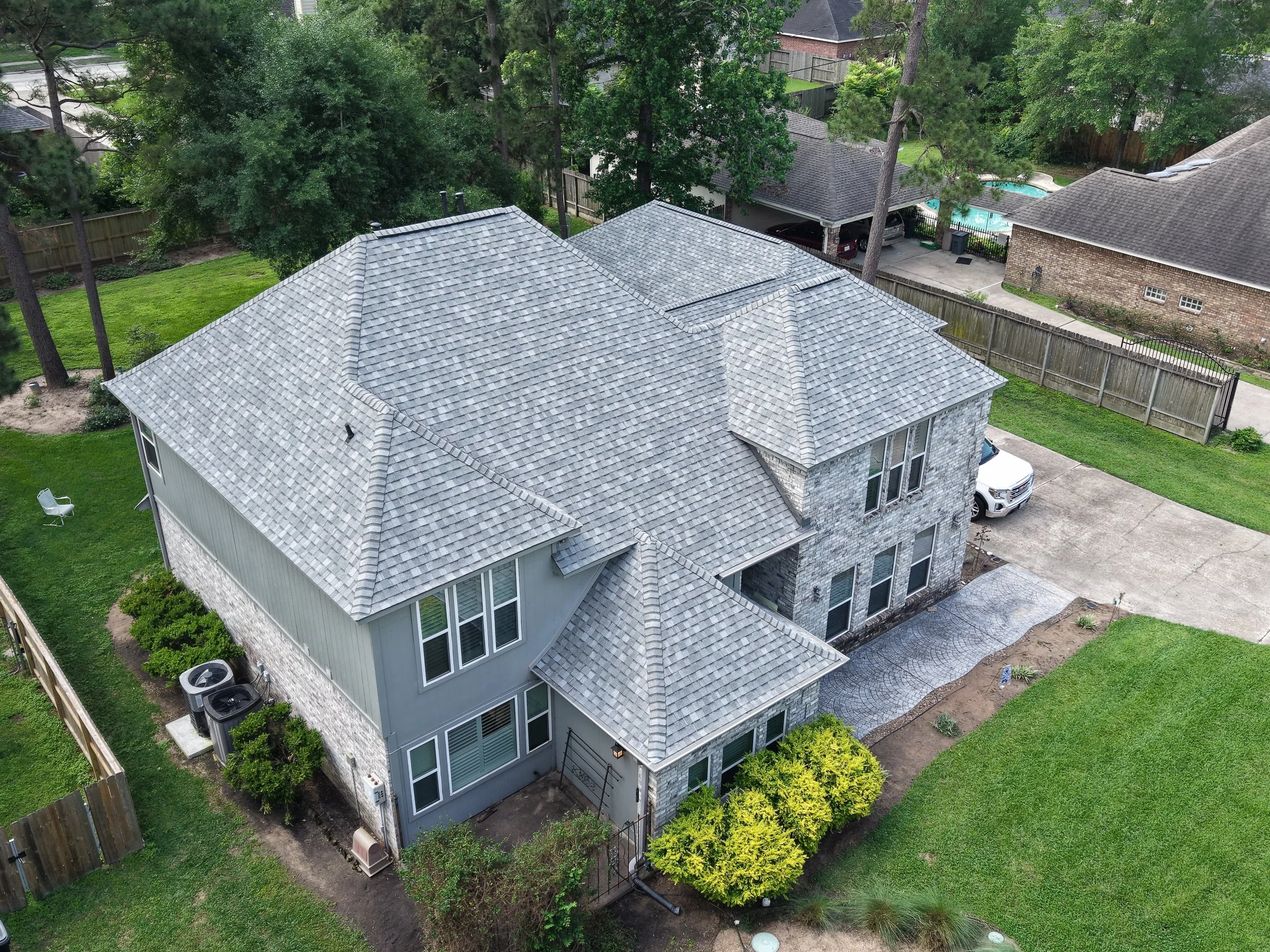 TurnKey Roofing & Restoration — An aerial view of a newly shingled large gray roof in Houston, Texas, using Owens Corning Shingles.
