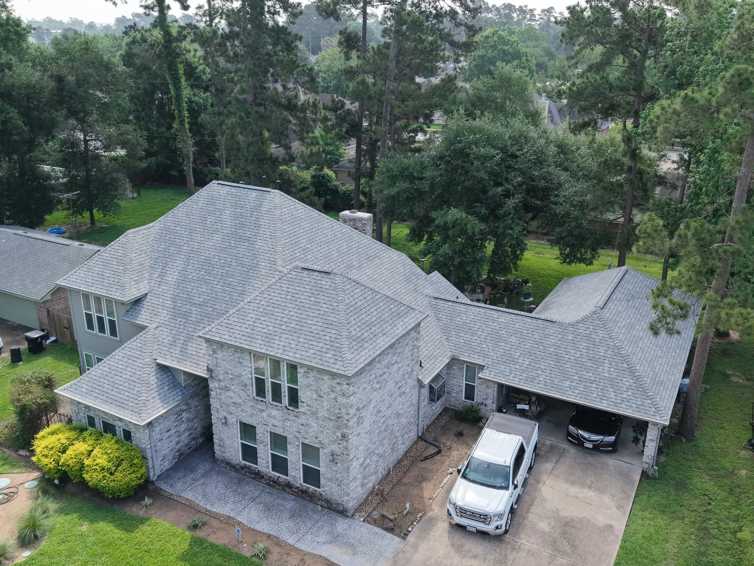 TurnKey Roofing & Restoration — An aerial view of a newly shingled large gray roof in Houston, Texas, using Owens Corning Shingles.