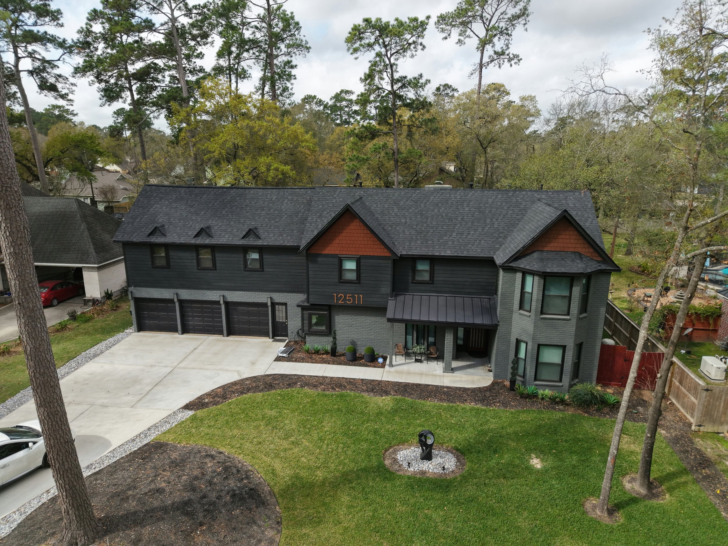 TurnKey Roofing & Restoration — An aerial view of a newly shingled large dark roof in Cypress (Houston), Texas, using Owens Corning Shingles.