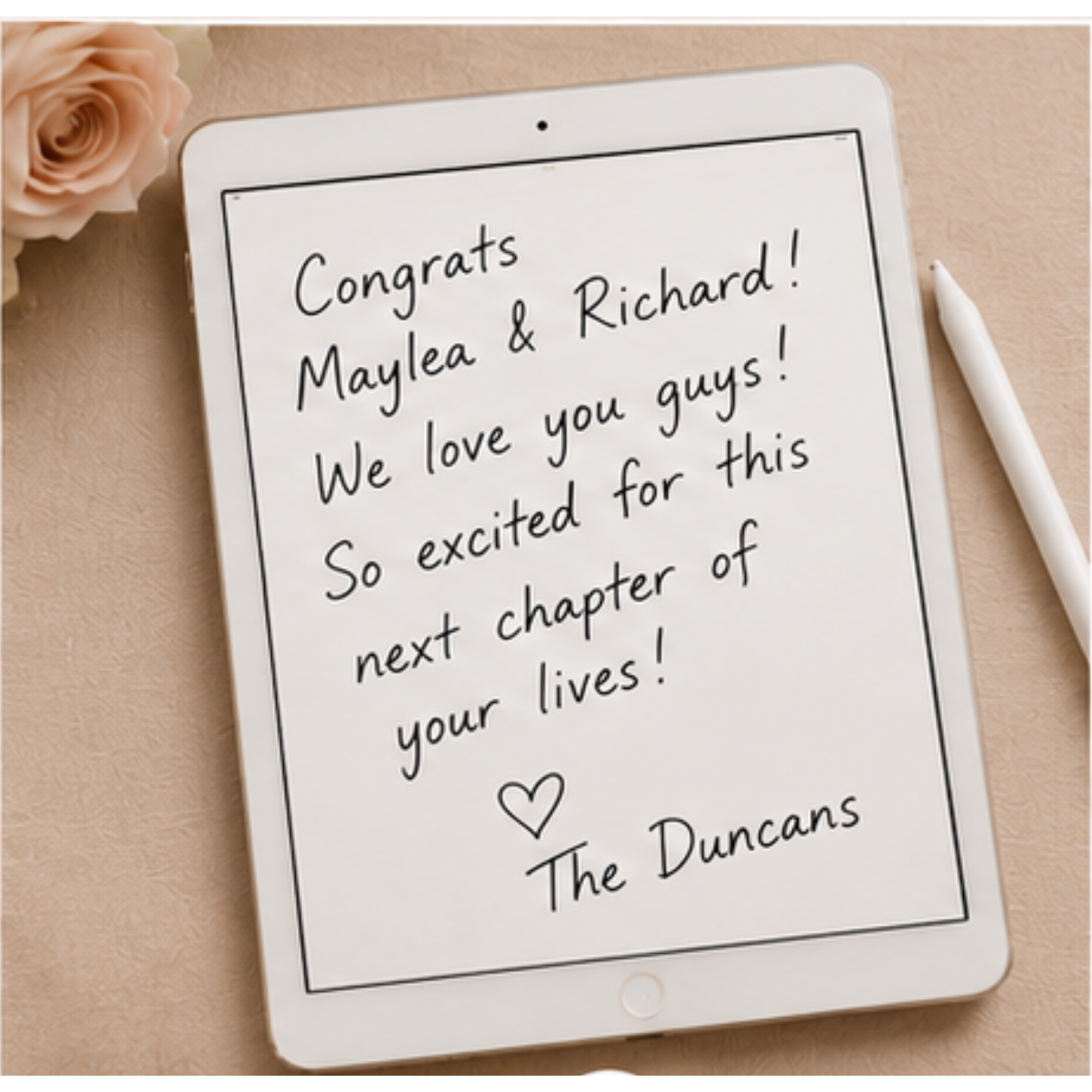 Tablet displaying a handwritten message with Congrats to Maylea and Richard, love notes, surrounded by a pale pink rose, a white marker, and a beige surface.