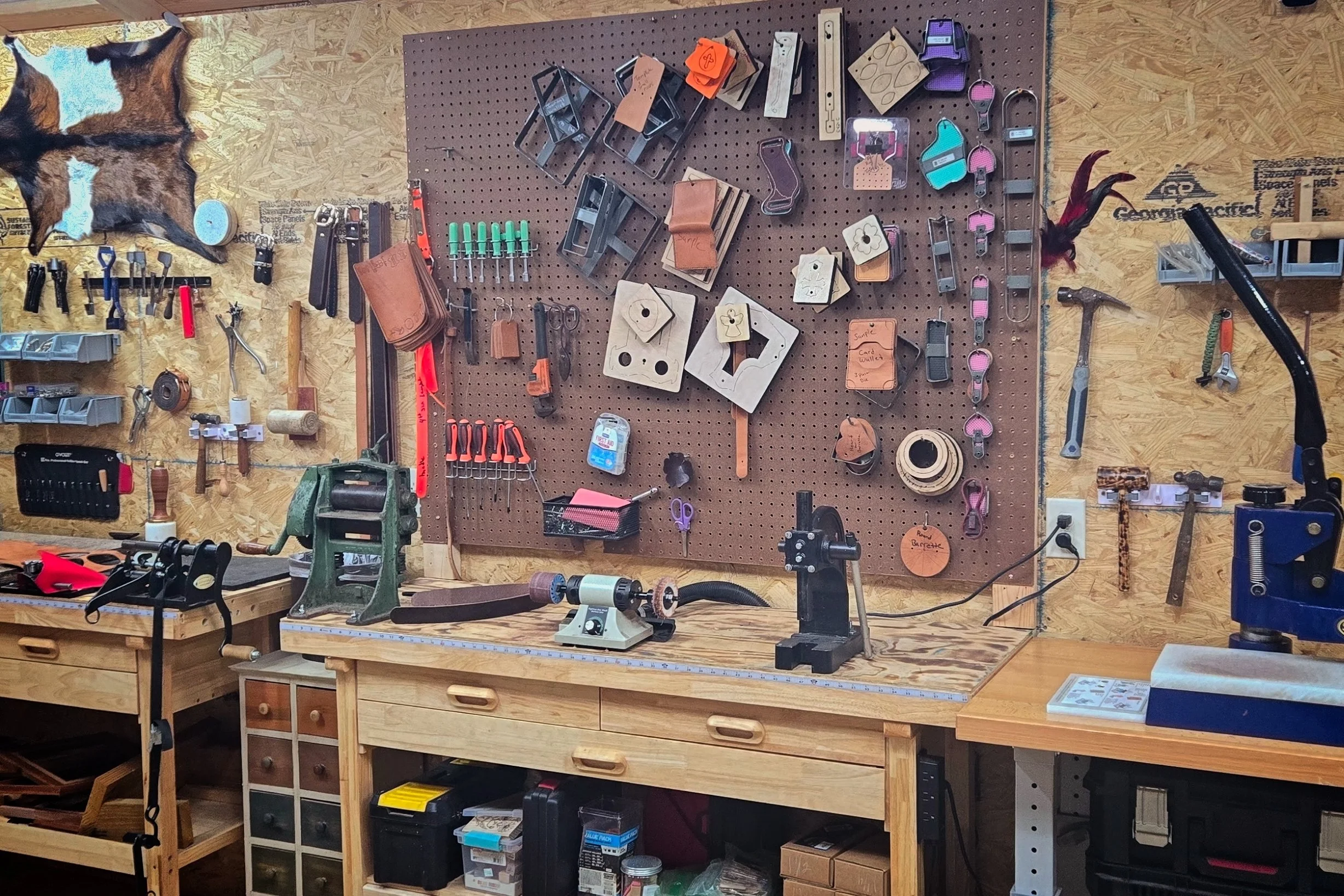 Our workshop wall with various leather tools tools and supplies.