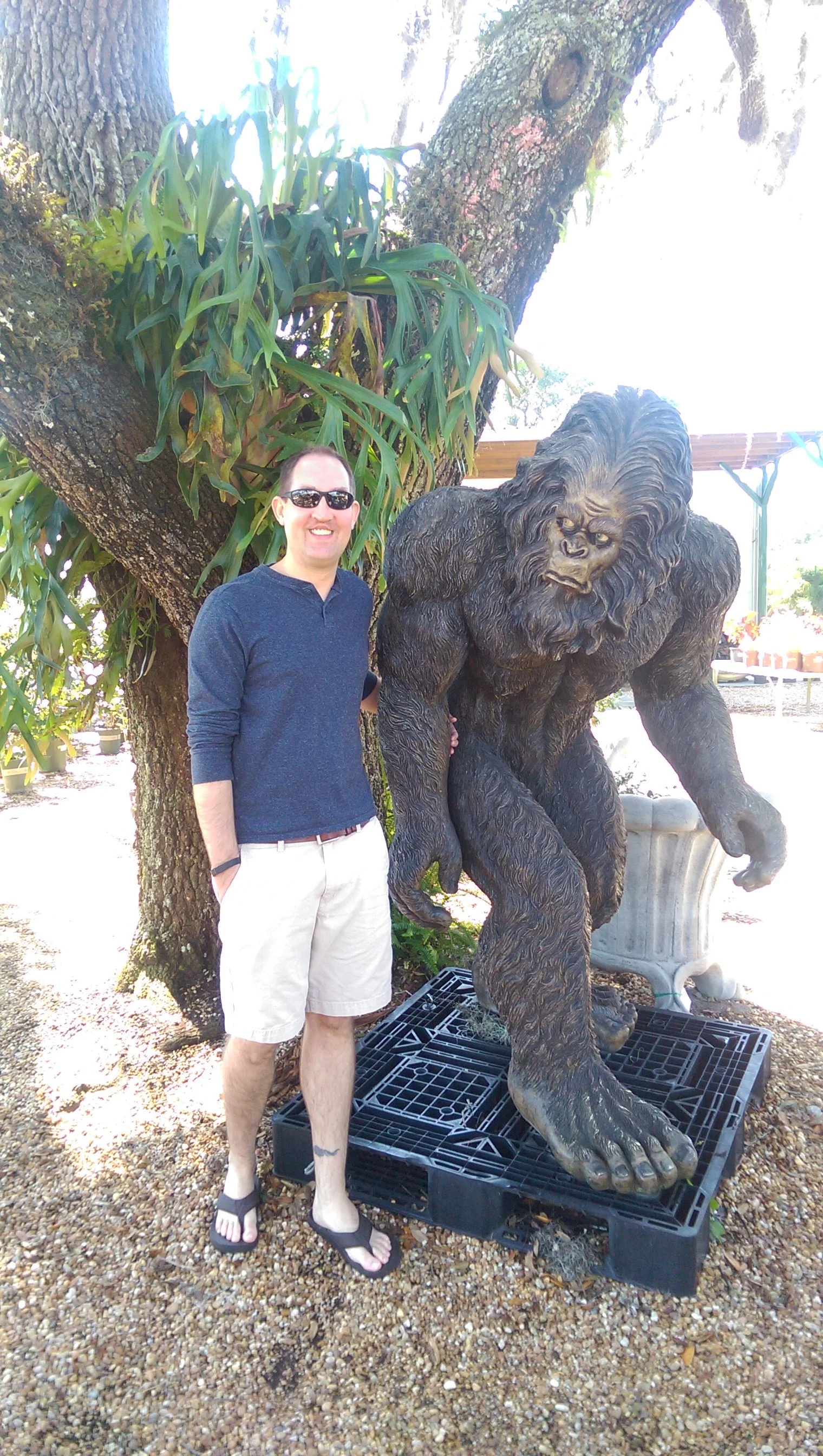 Brandon Gragg, CPA at Gragg Accounting & Tax, standing next to a Bigfoot sculpture