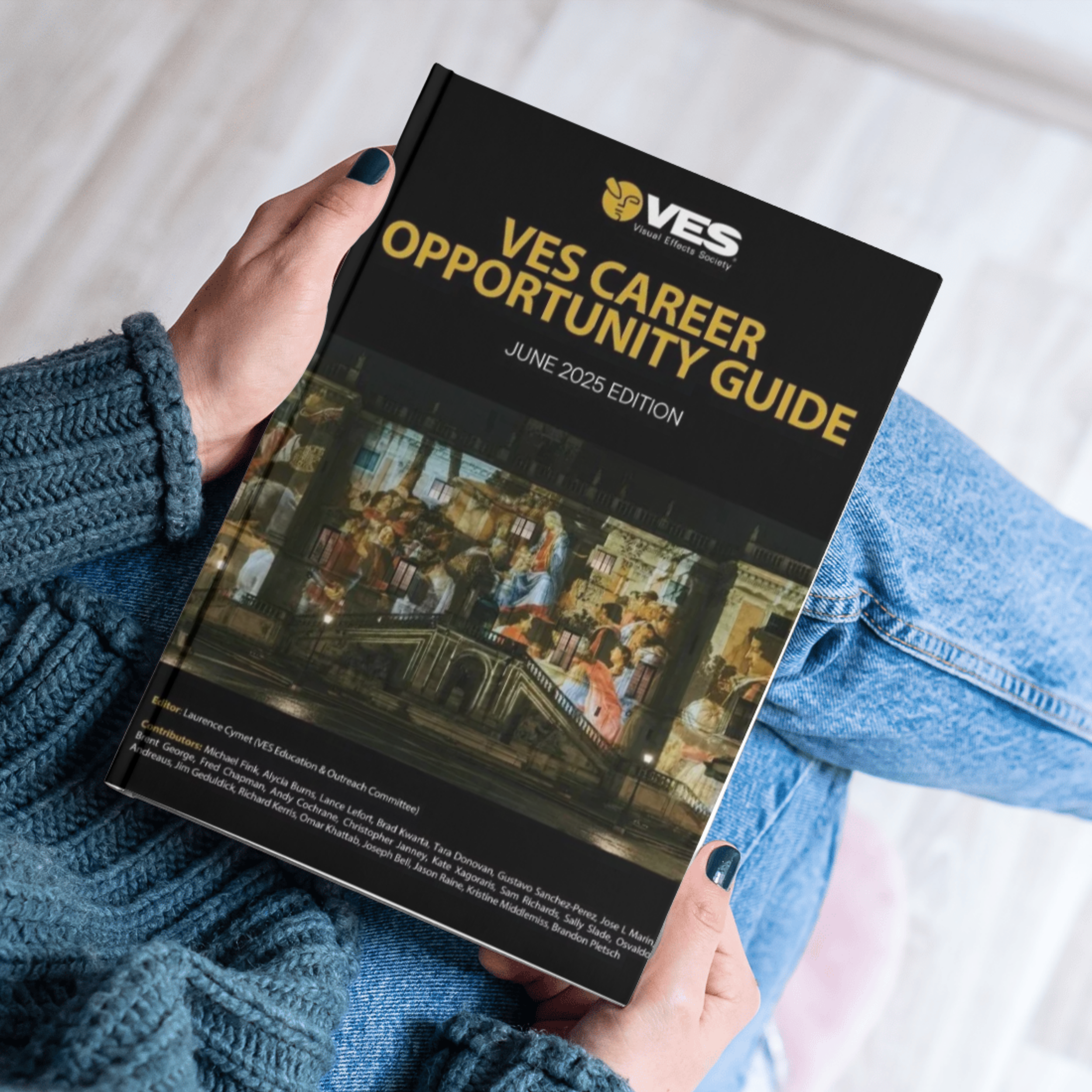 A person holding a report titled 'Ves Career Opportunity Guide' with the logo of the Visual Effects Society, showing a list of contributors.