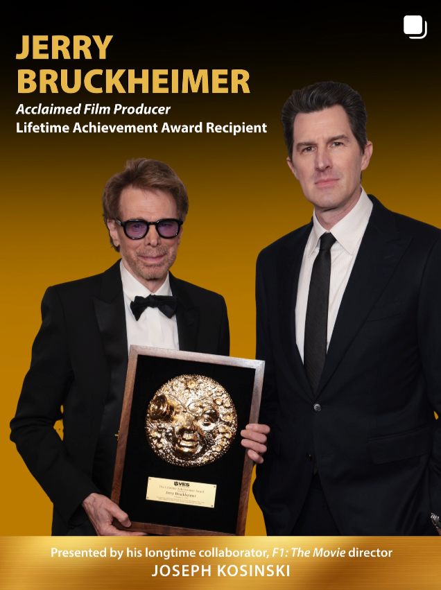 Image of Jerry Bruckheimer holding an award plaque with another man, both dressed in tuxedos, standing against a gold gradient background.